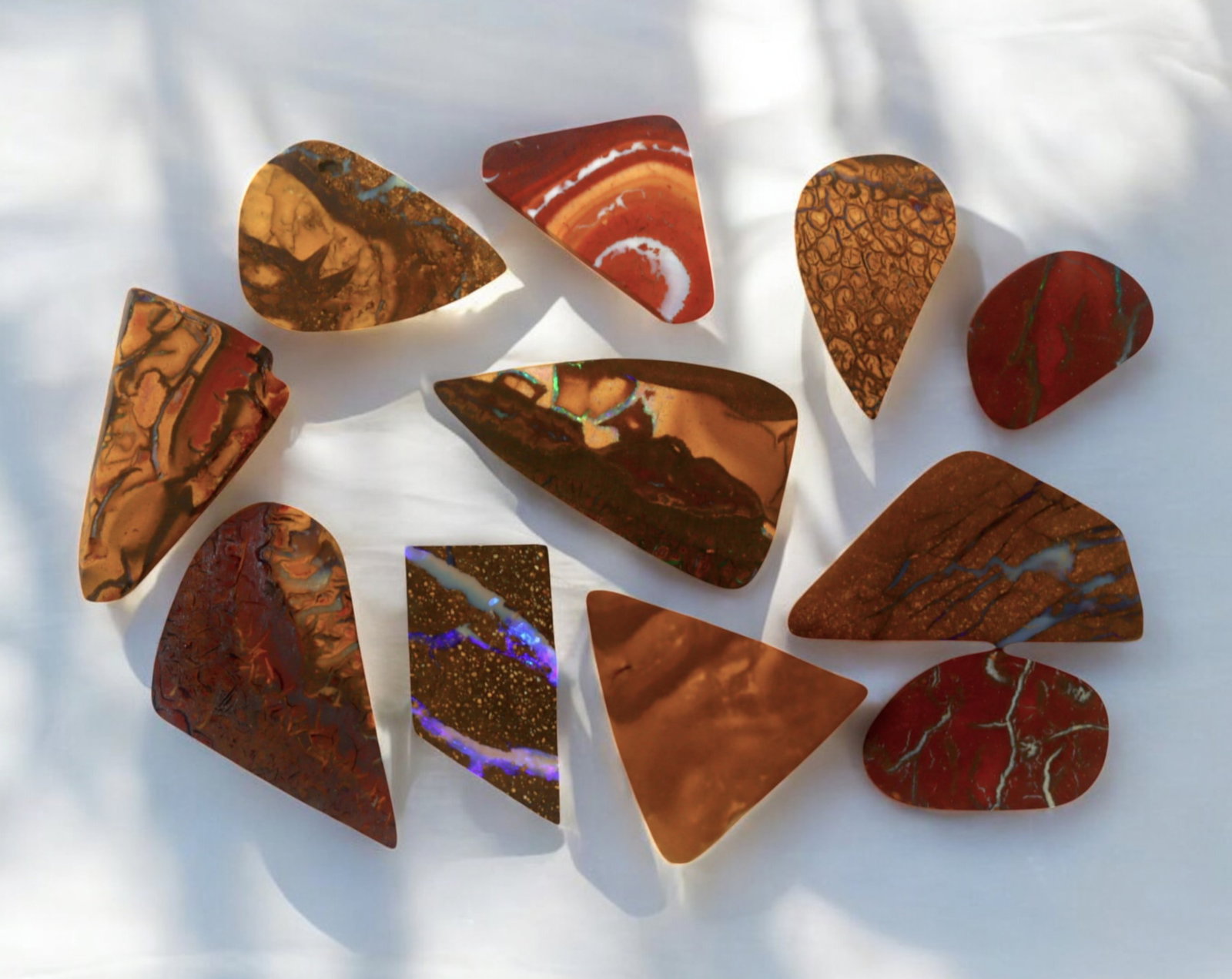 AUSTRALIA: Matrix Boulder Opal Preform Rough Lot, 19g, 1-2cm Each: A stunning selection of matrix boulder opal rough, sourced from Australia's renowned opal fields in Queensland. These preform-cut rough specimens display vivid flashes of blue, green, and purple opale