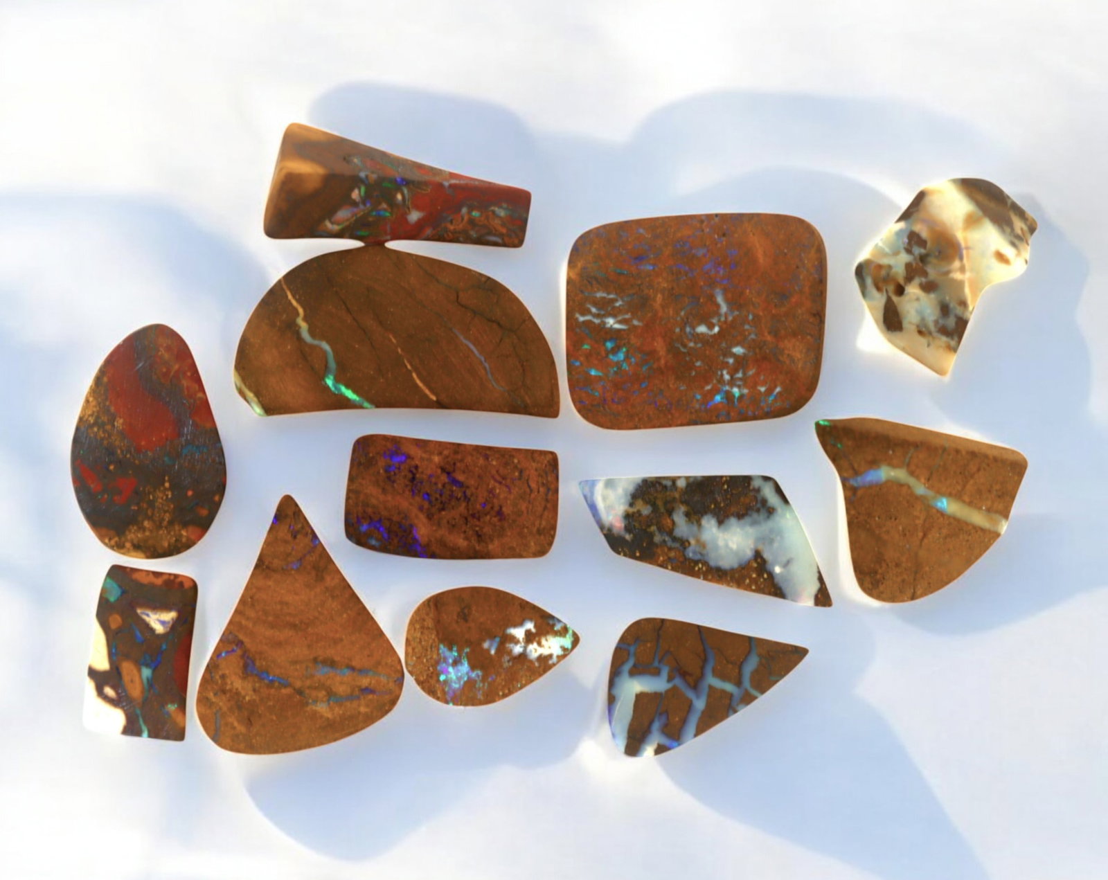 AUSTRALIA: Matrix Boulder Opal Preform Rough Lot, 19g, 1-2cm Each: A stunning selection of matrix boulder opal rough, sourced from Australia's renowned opal fields in Queensland. These preform-cut rough specimens display vivid flashes of blue, green, and purple opale