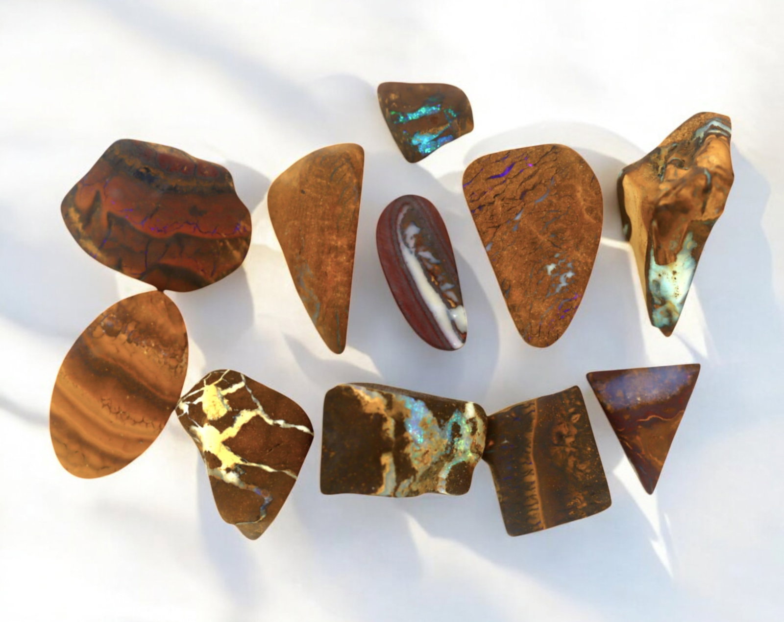 AUSTRALIA: Matrix Boulder Opal Preform Rough Lot, 28g, 1-2cm Each: A stunning selection of matrix boulder opal rough, sourced from Australia's renowned opal fields in Queensland. These preform-cut rough specimens display vivid flashes of blue, green, and purple opale