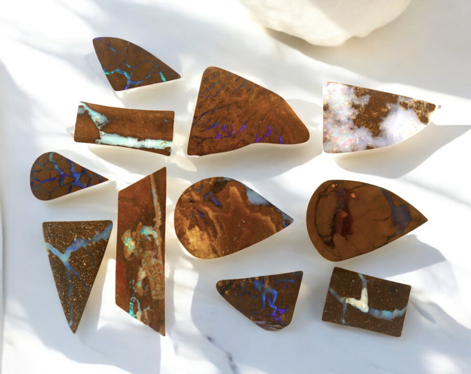 AUSTRALIA: Matrix Boulder Opal Preform Rough Lot, 19g, 1-2.5cm Each: A stunning selection of matrix boulder opal rough, sourced from Australia's renowned opal fields in Queensland. These preform-cut rough specimens display vivid flashes of blue, green, and purple opale