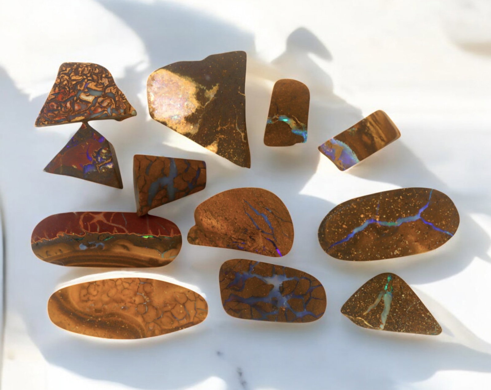 AUSTRALIA: Matrix Boulder Opal Preform Rough Lot, 21g, 1-2cm Each: A stunning selection of matrix boulder opal rough, sourced from Australia's renowned opal fields in Queensland. These preform-cut rough specimens display vivid flashes of blue, green, and purple opale