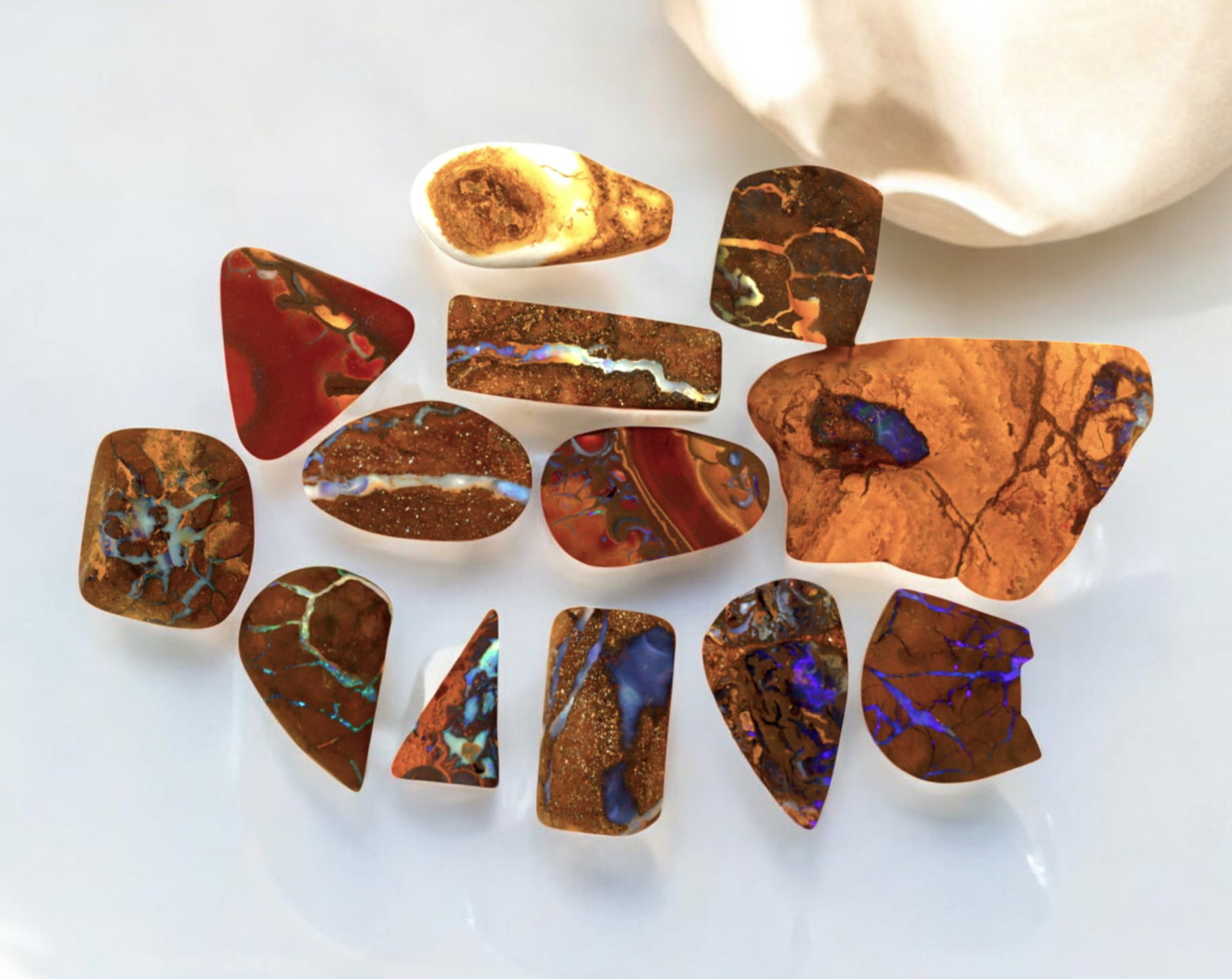 AUSTRALIA: Matrix Boulder Opal Preform Rough Lot, 24g, 1-3cm Each: A stunning selection of matrix boulder opal rough, sourced from Australia's renowned opal fields in Queensland. These preform-cut rough specimens display vivid flashes of blue, green, and purple opale