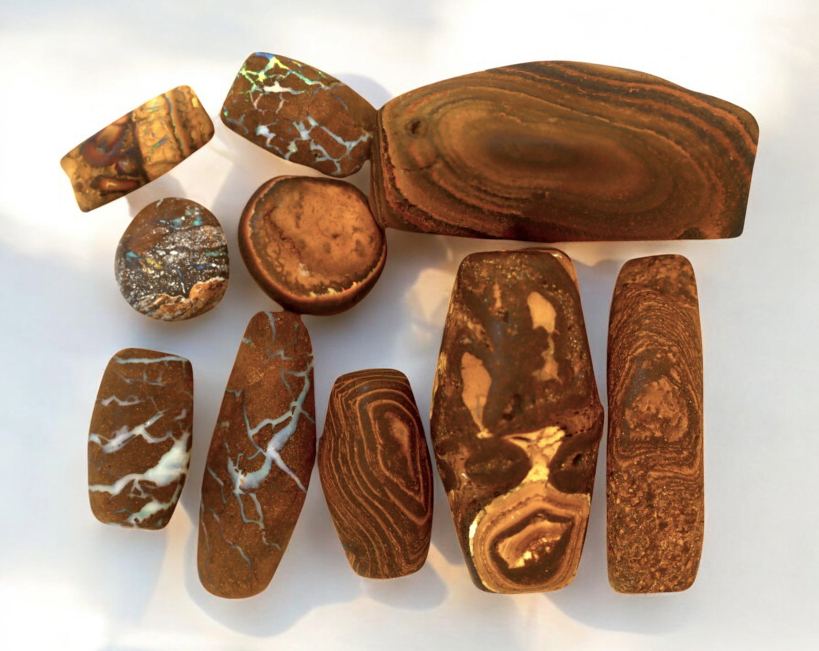 AUSTRALIA: Matrix Boulder Opal Preform Rough Lot, 68g, 1-3.5cm Each: A stunning selection of matrix boulder opal rough, sourced from Australia's renowned opal fields in Queensland. These preform-cut rough specimens display vivid flashes of blue, green, and purple opale