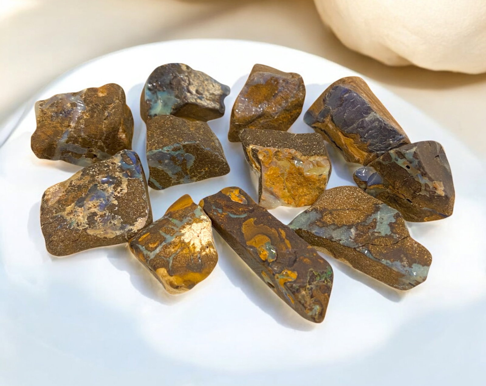 AUSTRALIAN MATRIX BOULDER OPAL - Rough Lot, 76g, 2-3cm Each: A striking lot of natural Australian matrix boulder opal rough, weighing a total of 76g, with individual pieces ranging from 2-3cm in size. These raw specimens display mesmerizing flashes of blue, gre