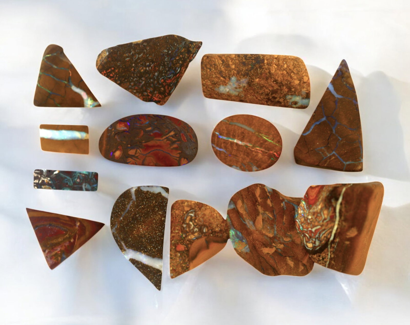 AUSTRALIA: Matrix Boulder Opal Preform Rough Lot, 26g, 1-2cm Each: A stunning selection of matrix boulder opal rough, sourced from Australia's renowned opal fields in Queensland. These preform-cut rough specimens display vivid flashes of blue, green, and purple opale
