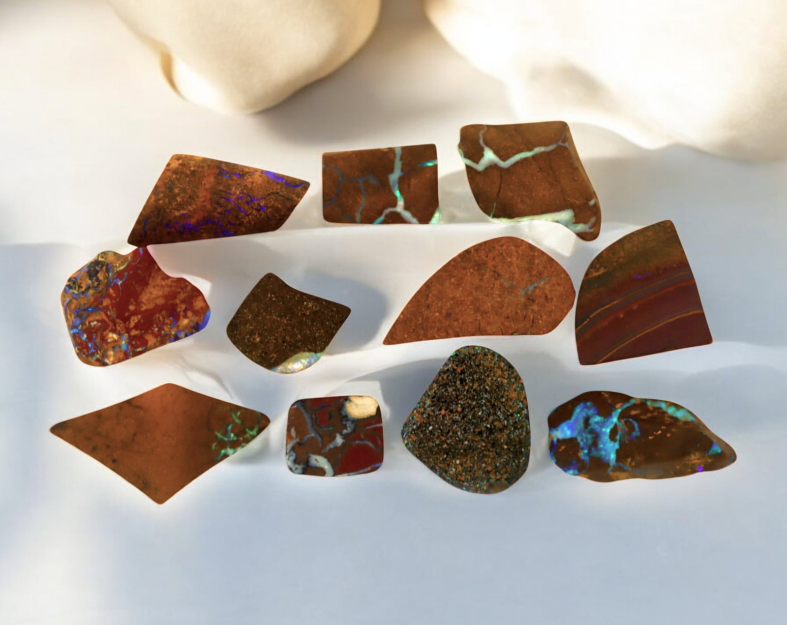 AUSTRALIA: Matrix Boulder Opal Preform Rough Lot, 27g, 1-2.5cm Each: A stunning selection of matrix boulder opal rough, sourced from Australia's renowned opal fields in Queensland. These preform-cut rough specimens display vivid flashes of blue, green, and purple opale