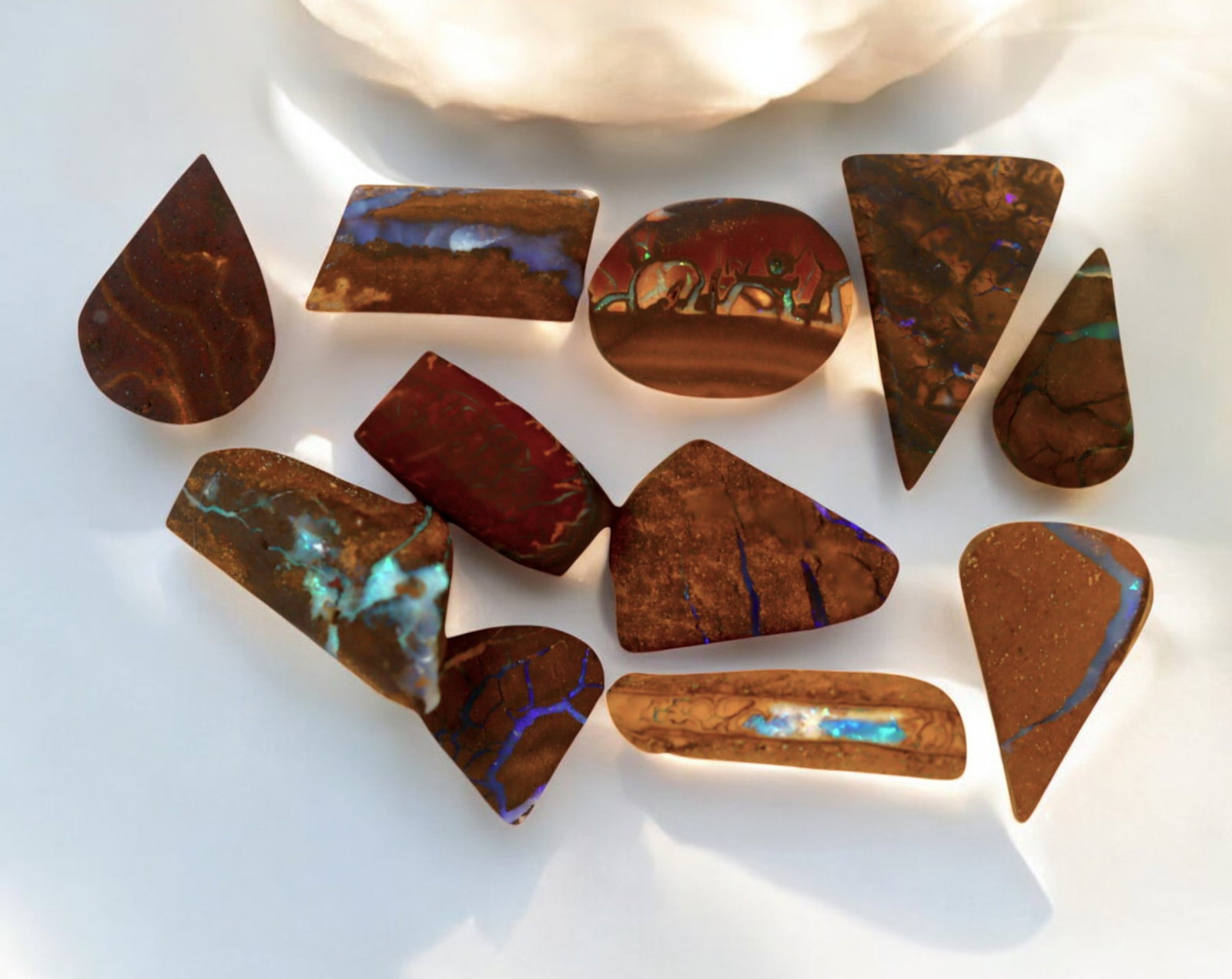 AUSTRALIA: Matrix Boulder Opal Preform Rough Lot, 21g, 1-2.5cm Each: A stunning selection of matrix boulder opal rough, sourced from Australia's renowned opal fields in Queensland. These preform-cut rough specimens display vivid flashes of blue, green, and purple opale