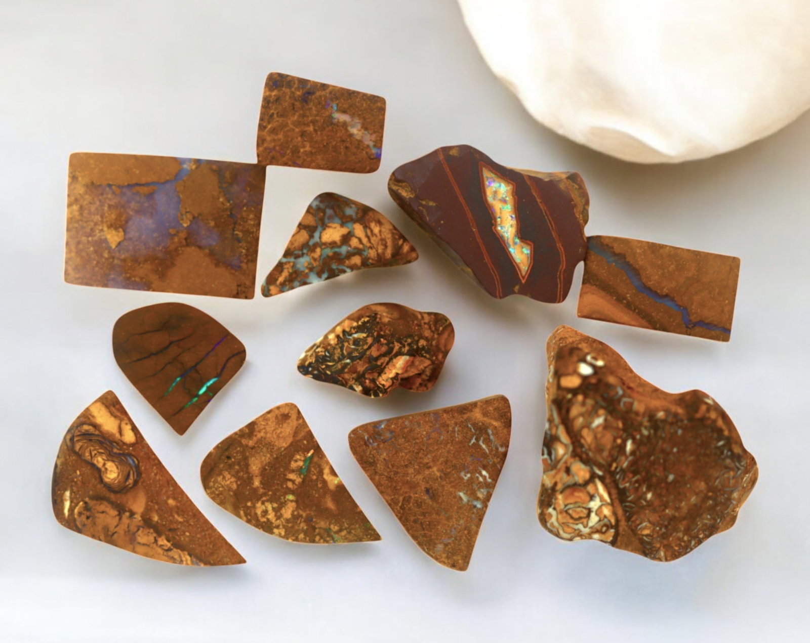 AUSTRALIA: Matrix Boulder Opal Preform Rough Lot, 17g, 1-2cm Each: A stunning selection of matrix boulder opal rough, sourced from Australia's renowned opal fields in Queensland. These preform-cut rough specimens display vivid flashes of blue, green, and purple opale