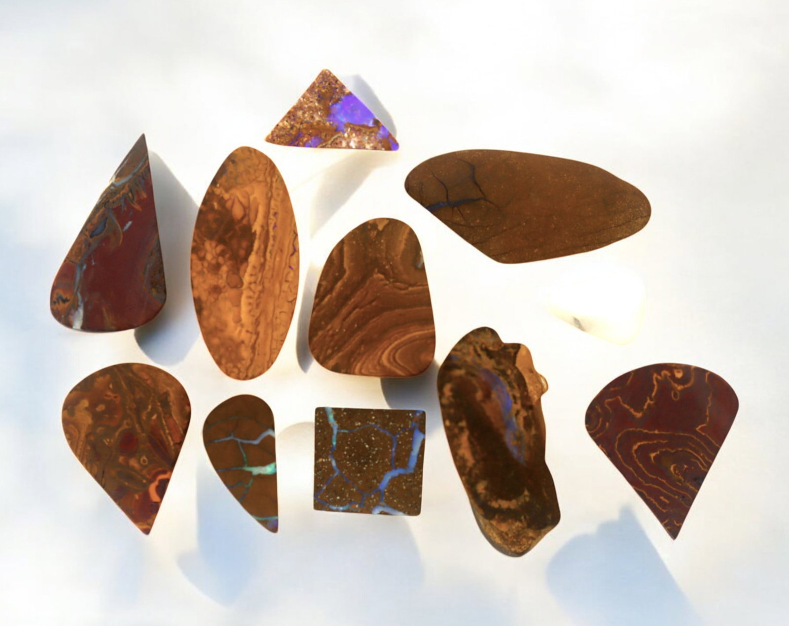 AUSTRALIA: Matrix Boulder Opal Preform Rough Lot, 17g, 1-2.5cm Each: A stunning selection of matrix boulder opal rough, sourced from Australia's renowned opal fields in Queensland. These preform-cut rough specimens display vivid flashes of blue, green, and purple opale