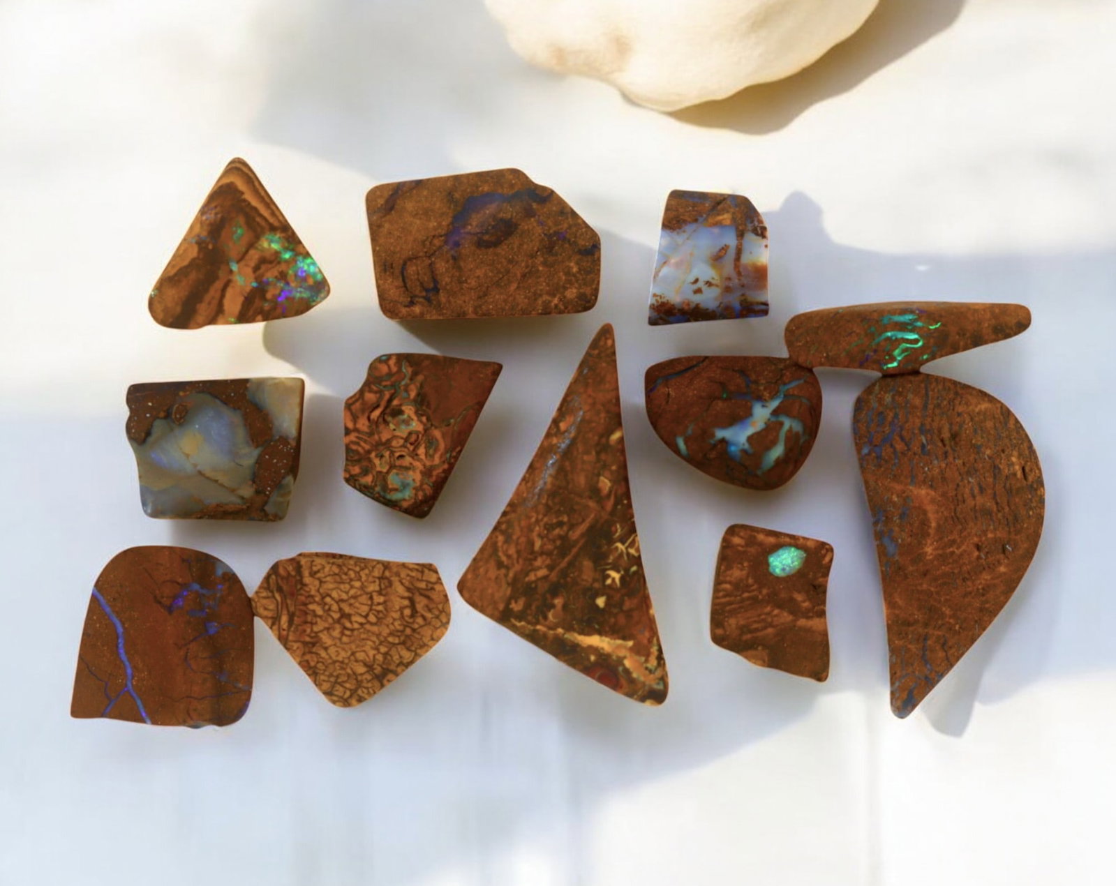 AUSTRALIA: Matrix Boulder Opal Preform Rough Lot, 20g, 1-2.5cm Each: A stunning selection of matrix boulder opal rough, sourced from Australia's renowned opal fields in Queensland. These preform-cut rough specimens display vivid flashes of blue, green, and purple opale