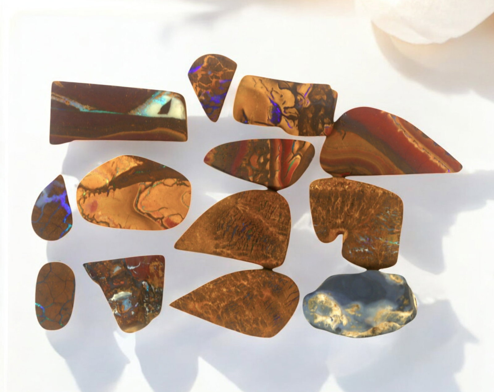 AUSTRALIA: Matrix Boulder Opal Preform Rough Lot, 23g, 1-2.5cm Each: A stunning selection of matrix boulder opal rough, sourced from Australia's renowned opal fields in Queensland. These preform-cut rough specimens display vivid flashes of blue, green, and purple opale