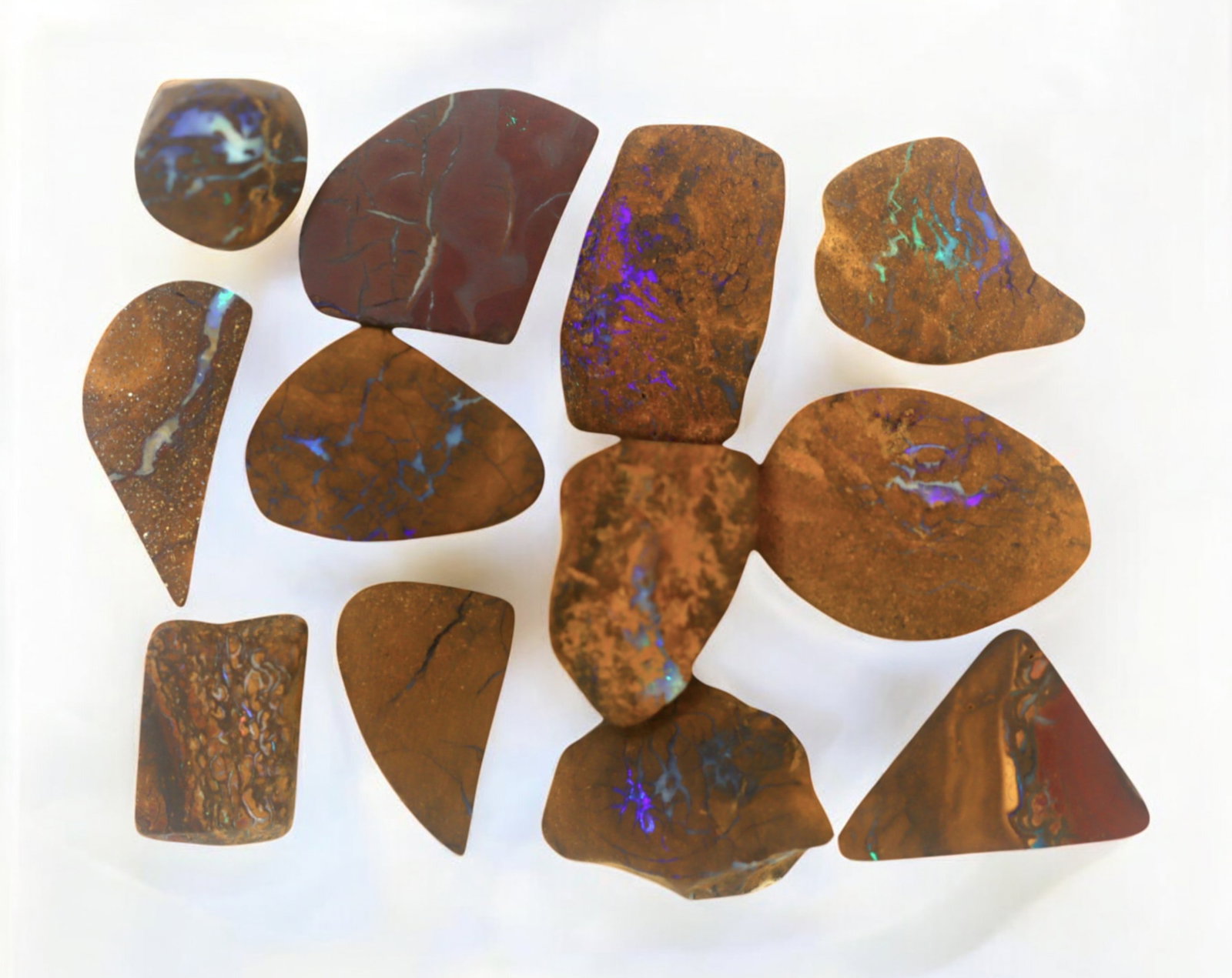 AUSTRALIA: Matrix Boulder Opal Preform Rough Lot, 26g, 1.5-2cm Each: A stunning selection of matrix boulder opal rough, sourced from Australia's renowned opal fields in Queensland. These preform-cut rough specimens display vivid flashes of blue, green, and purple opale