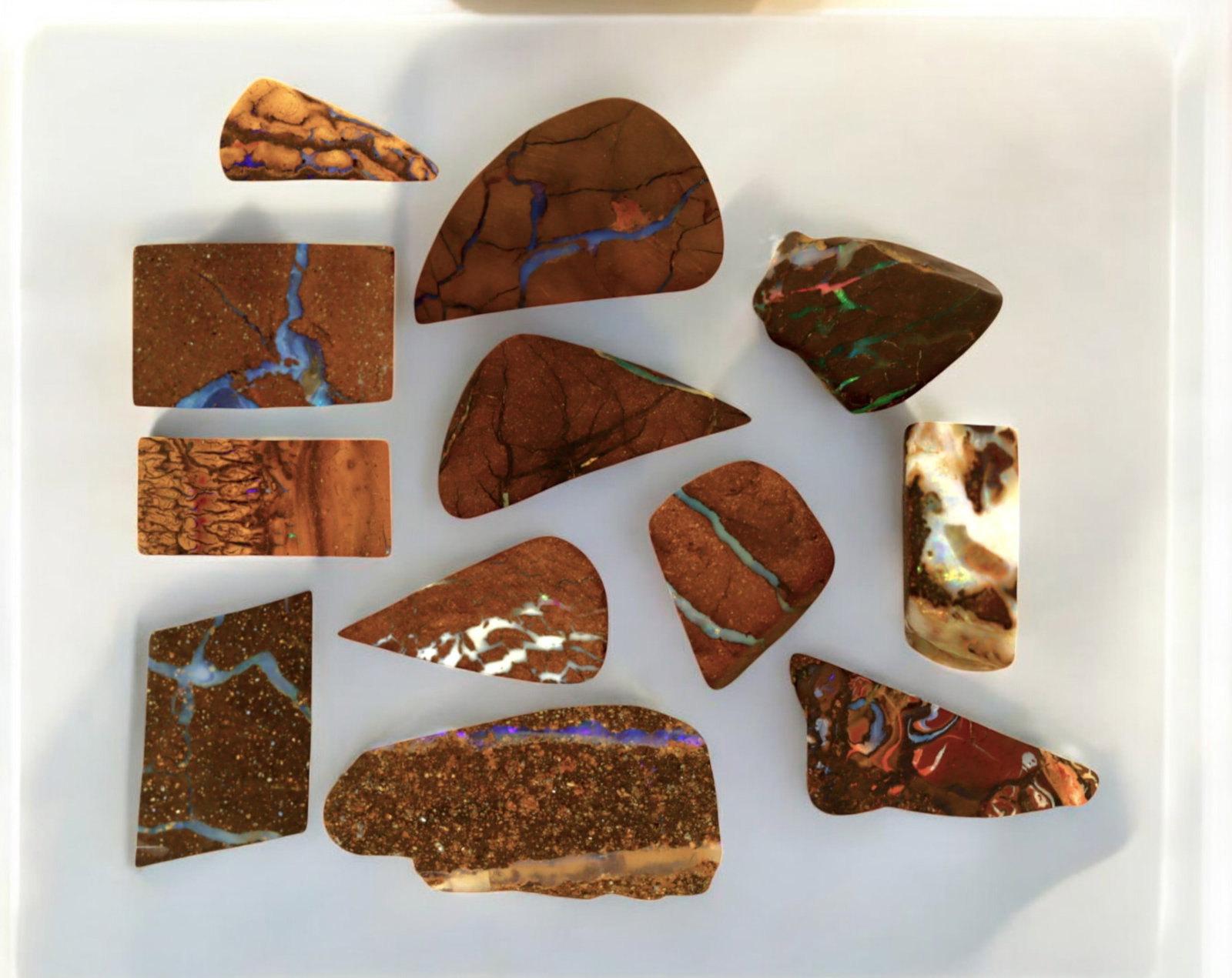AUSTRALIA: Matrix Boulder Opal Preform Rough Lot, 21g, 1.5-2.5cm Each: A stunning selection of matrix boulder opal rough, sourced from Australia's renowned opal fields in Queensland. These preform-cut rough specimens display vivid flashes of blue, green, and purple opale