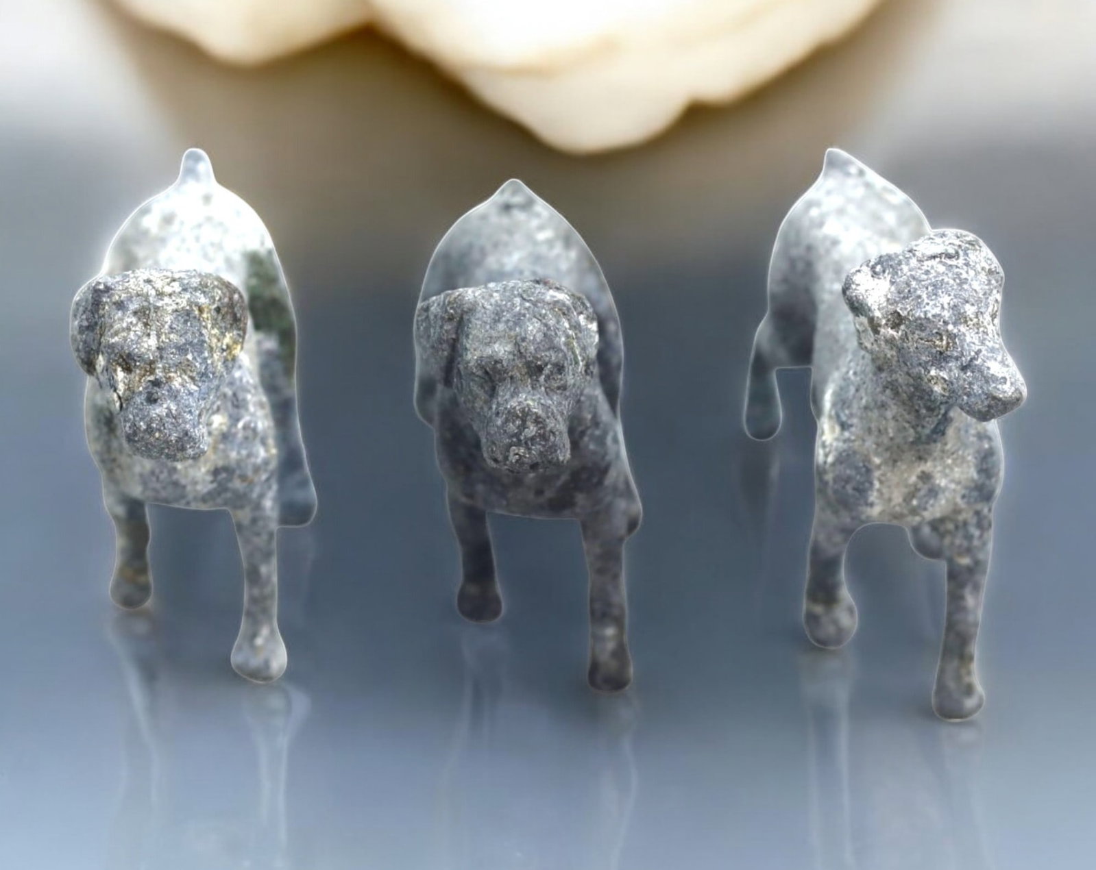 VINTAGE LEAD DOG FIGURINES: This lot featuresvintage lead dog figurines, each crafted with attention to canine anatomy and stance. The figures exhibit subtle variations in posture and detail, suggesting different breeds or styli