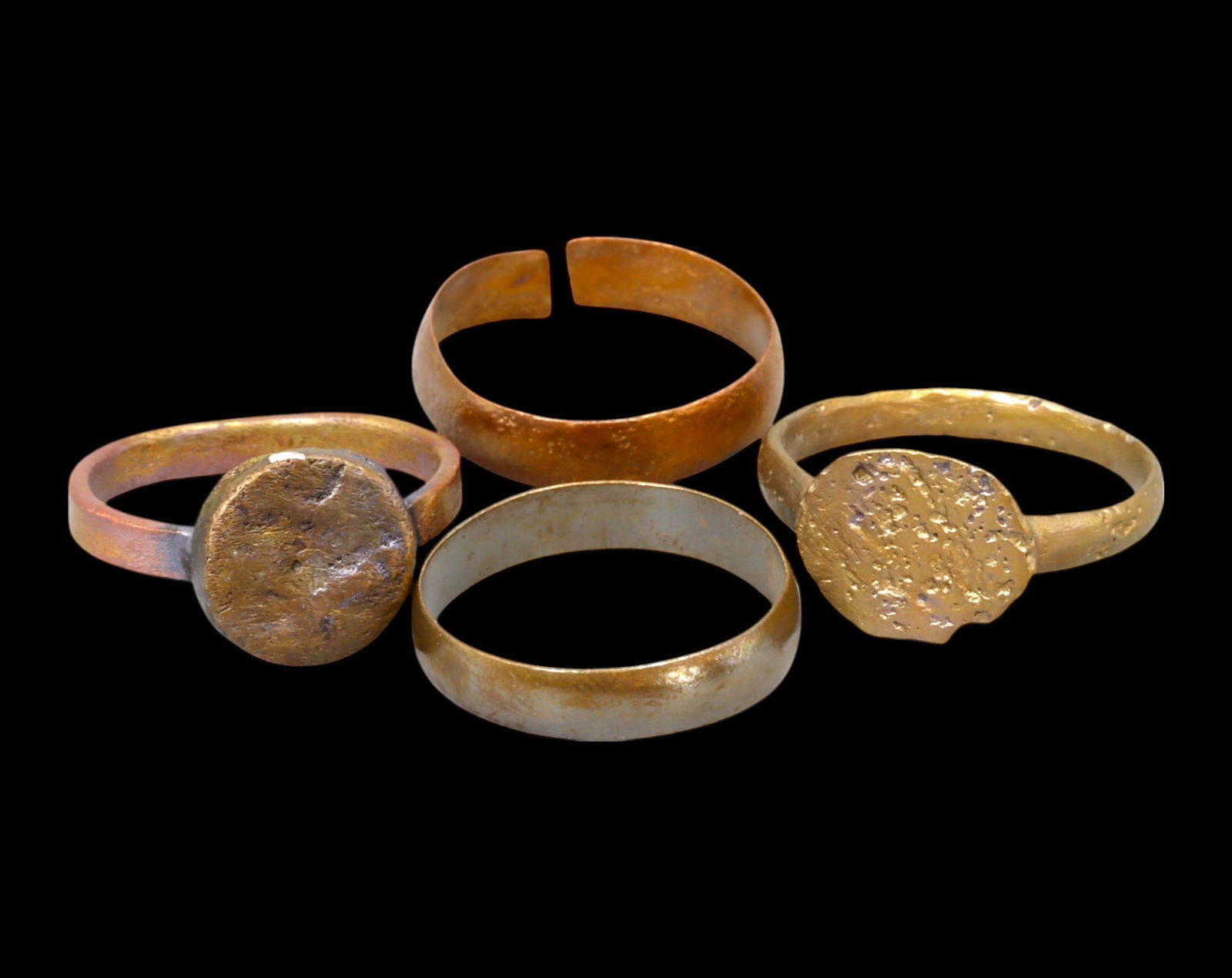 VIKING AGE: Lot of Bronze & Brass Engagement or Wedding Rings - 9th-11th Century: A captivating set of Viking-era engagement or wedding rings, crafted in bronze and brass. These finely shaped rings exhibit a rich patina, with some featuring smooth, polished surfaces while others re