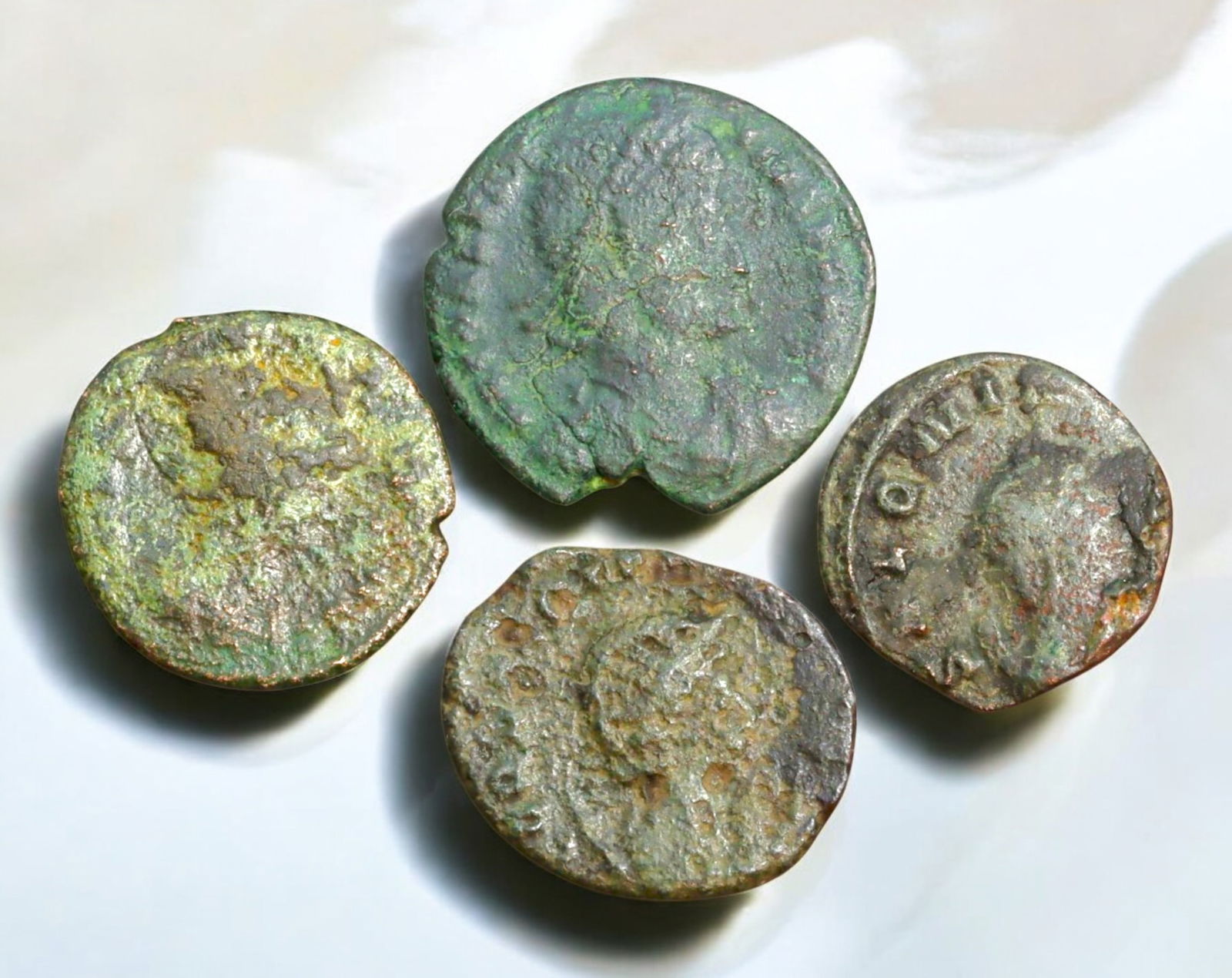 ROMAN EMPIRE: AE Coins - Bronze Coins, 17-21mm, 11g (Lot of 4): A collection of ancient Roman bronze coins, each featuring a distinct imperial portrait on the obverse and various symbolic or military-themed reverses. These coins, essential to Roman commerce and go