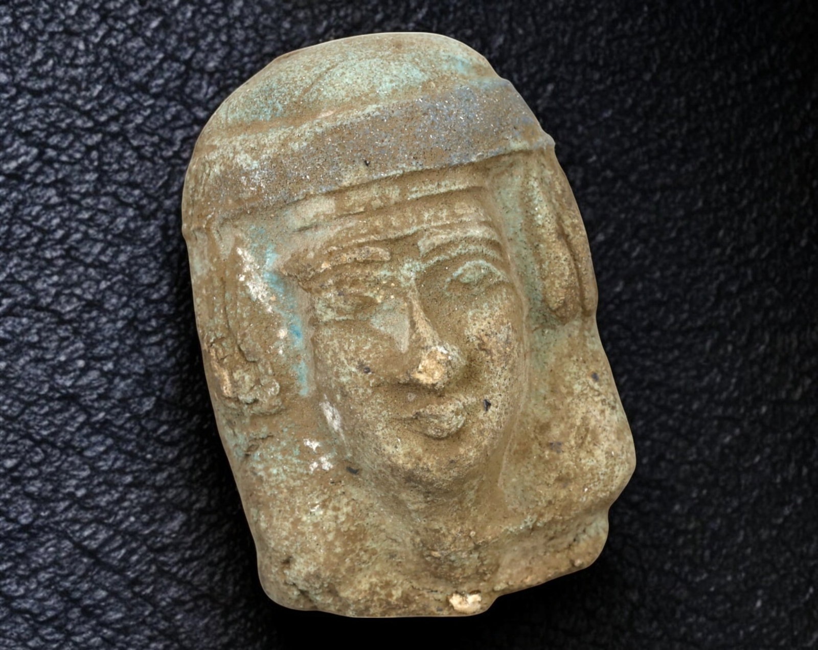 EGYPTIAN REVIVAL: Terracotta Head Fragment - Faience-Style, 19th/20th Century, 7.5x5cm, 175g: A finely crafted Egyptian Revival terracotta head fragment, measuring 7.5 x 5 cm and weighing 175g. Modeled in the ancient faience style, this piece features a serene, well-defined visage adorned with
