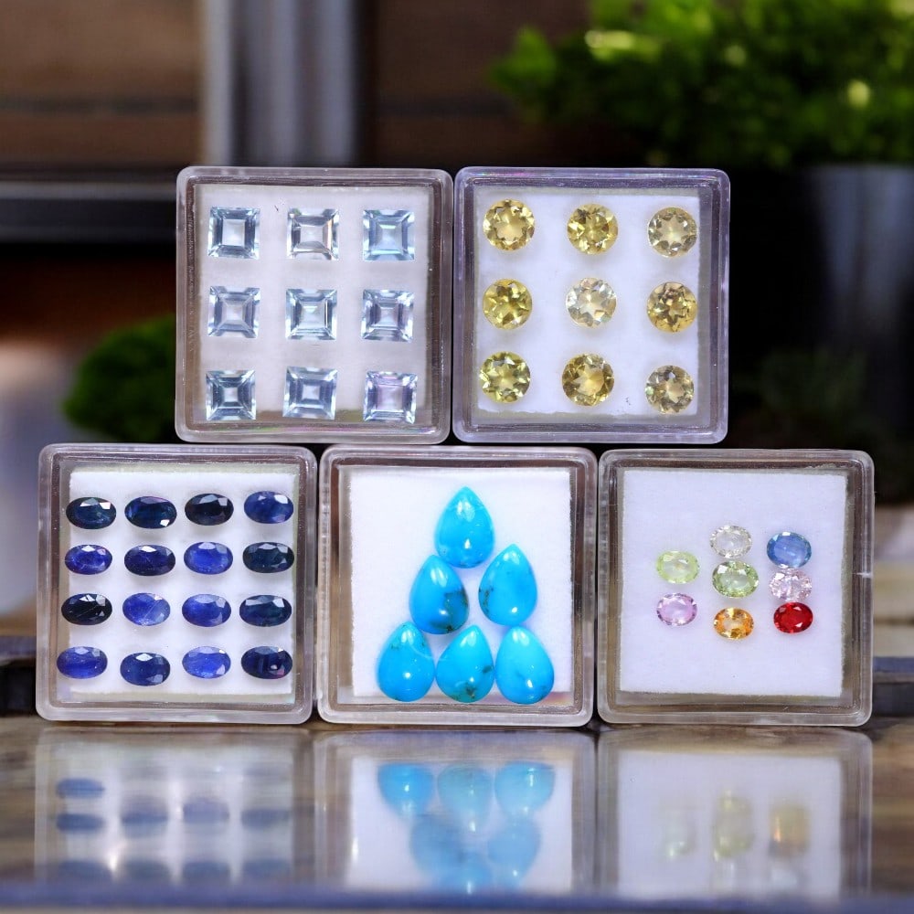 Blue Sapphire, Arizona Turquoise, Citrine, Fancy Sapphire & Blue Topaz: An exquisite selection of premium gemstones offering a dynamic mix of colors and brilliance. This collection includes sixteen oval-cut Blue Sapphires, totaling 4.87 carats (4.7x3.1x1.7mm each), displa
