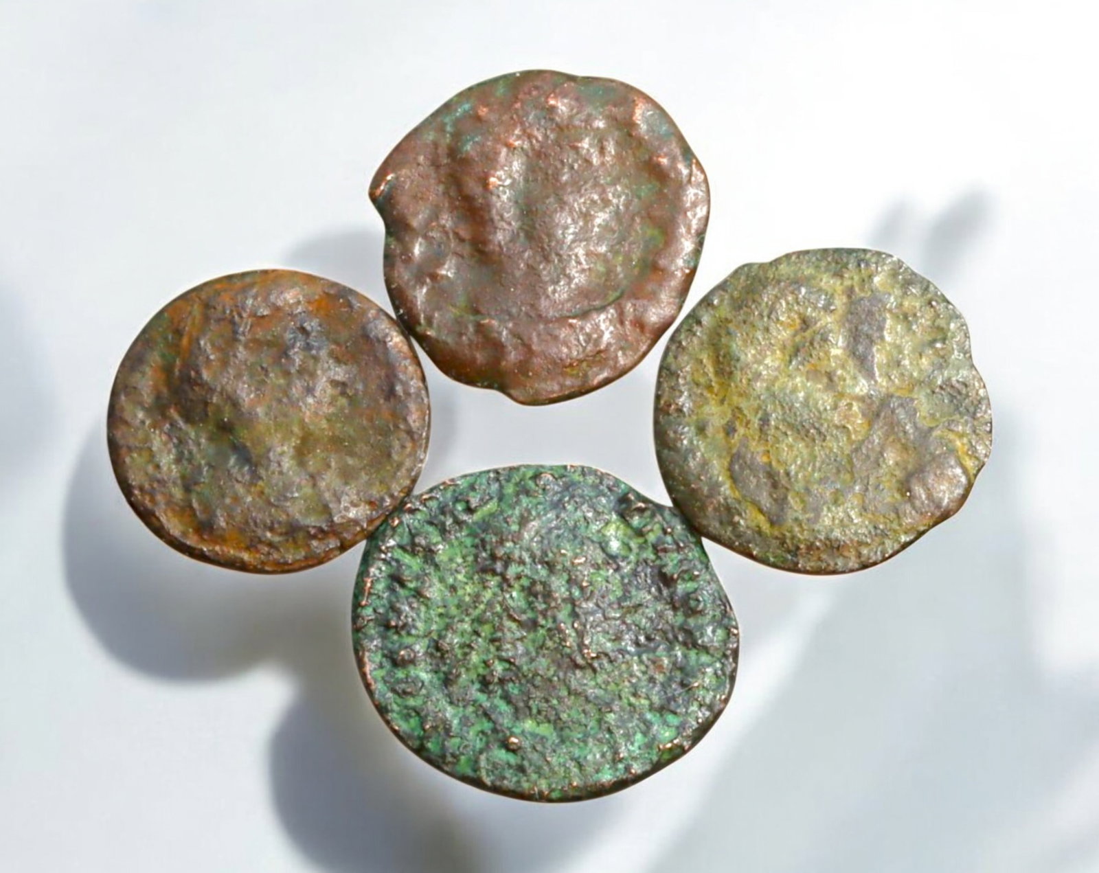 ROMAN EMPIRE: AE Coins - Bronze Coins, 14-17mm, 5.3g (Lot of 4): A collection of ancient Roman bronze coins, each featuring a distinct imperial portrait on the obverse and various symbolic or military-themed reverses. These coins, essential to Roman commerce and go
