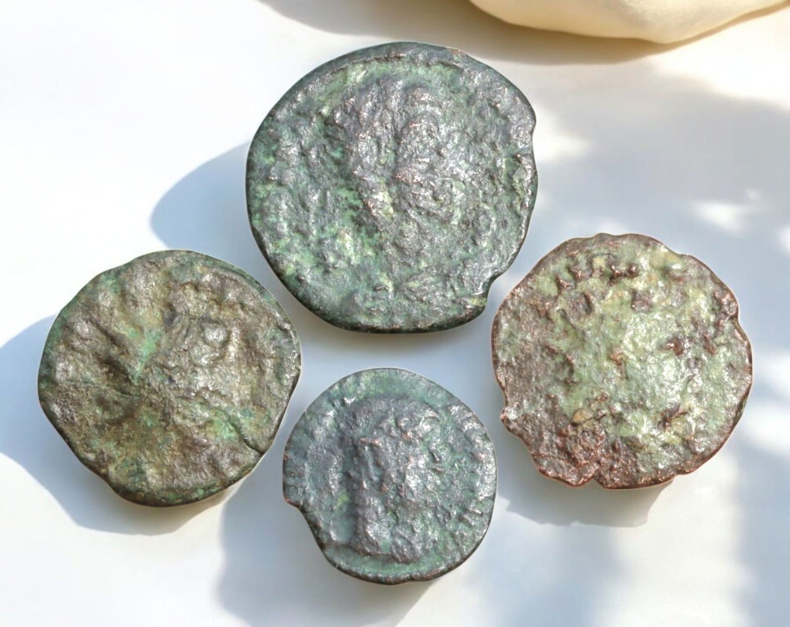 ROMAN EMPIRE: AE Coins - Bronze Coins, 14-20mm, 7g (Lot of 4): A collection of ancient Roman bronze coins, each featuring a distinct imperial portrait on the obverse and various symbolic or military-themed reverses. These coins, essential to Roman commerce and go