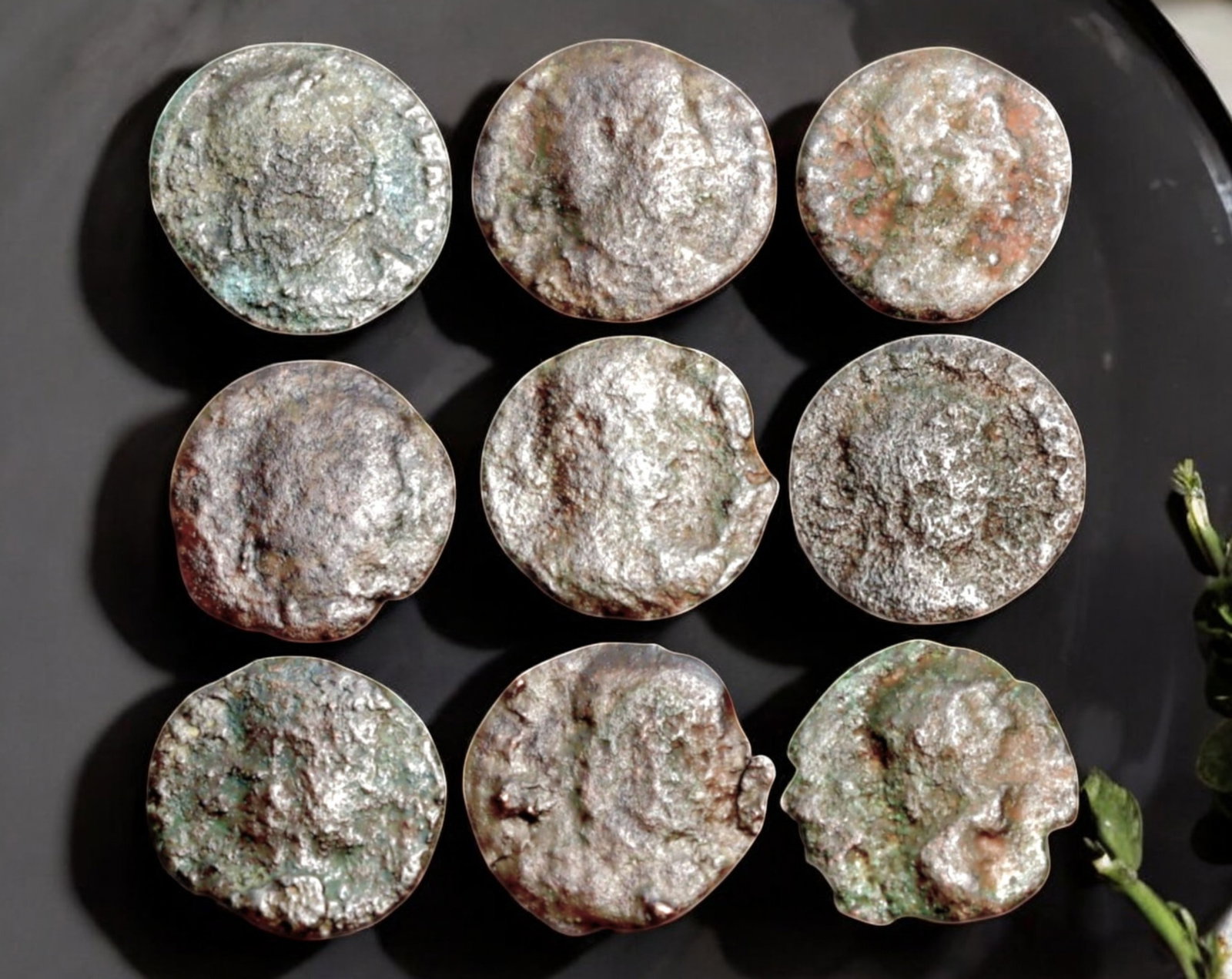 ROMAN EMPIRE: AE Coins - Bronze Coins, 13-15mm, 8.8g (Lot of 9): A collection of ancient Roman bronze coins, each featuring a distinct imperial portrait on the obverse and various symbolic or military-themed reverses. These coins, essential to Roman commerce and go