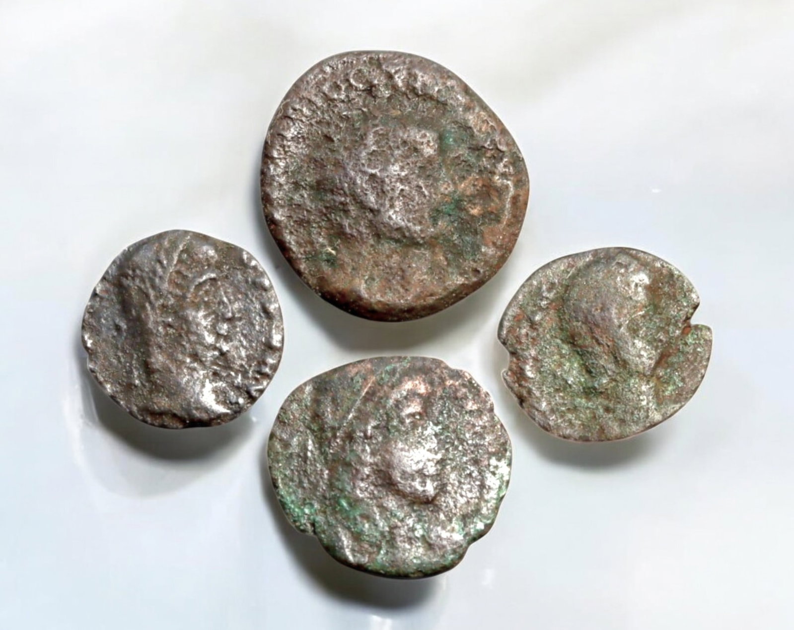 ROMAN EMPIRE: AE Coins - Bronze Coins, 13-19mm, 4.5g (Lot of 4): A collection of ancient Roman bronze coins, each featuring a distinct imperial portrait on the obverse and various symbolic or military-themed reverses. These coins, essential to Roman commerce and go