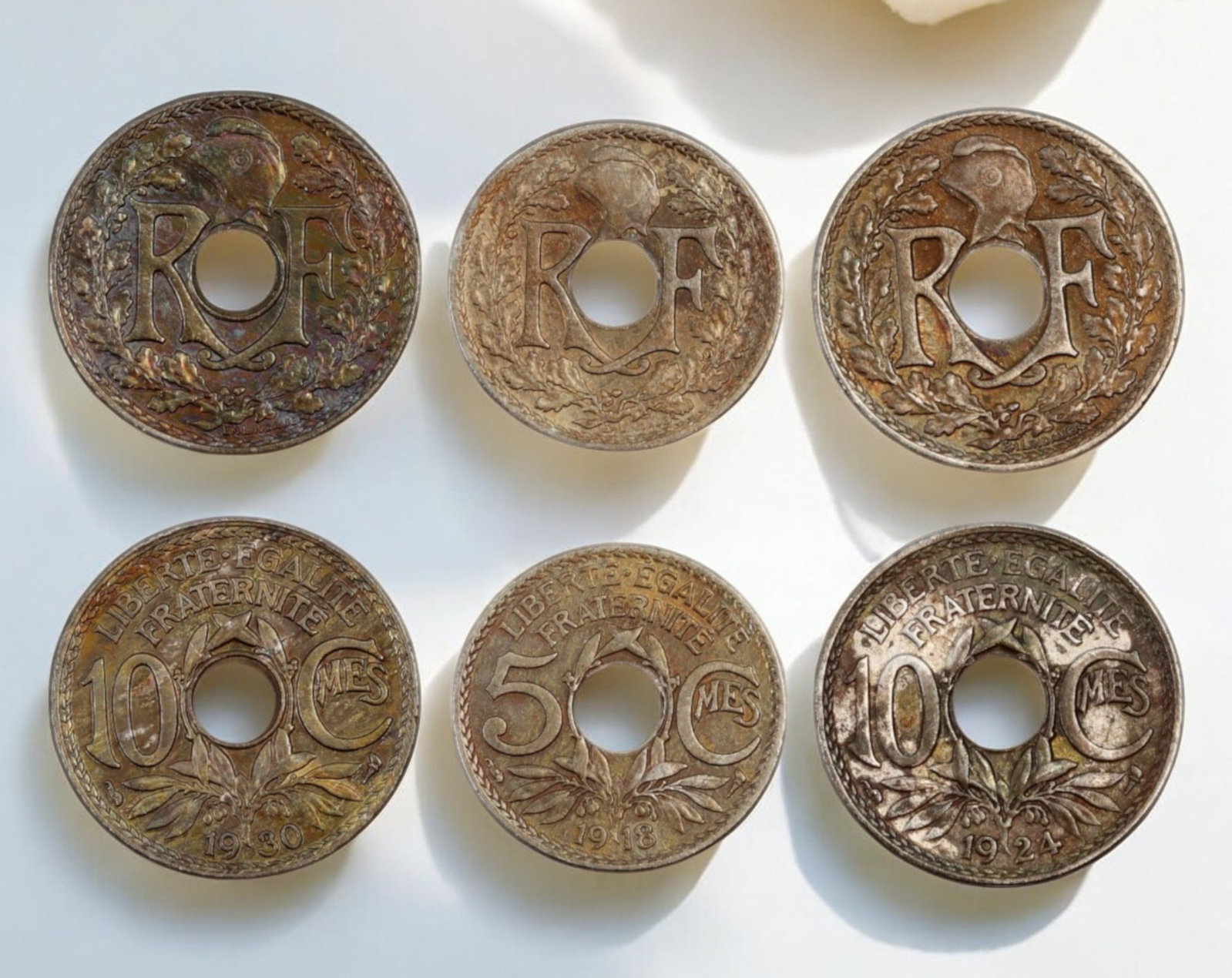 FRANCE: Holed Coin Lot - 3pcs, 19-21mm, 11g (1918-1930): A fascinating trio of early 20th-century French holed coins, featuring denominations of 5 and 10 centimes, minted between 1918 and 1930. These classic designs showcase the iconic "RF" (Republique Fran