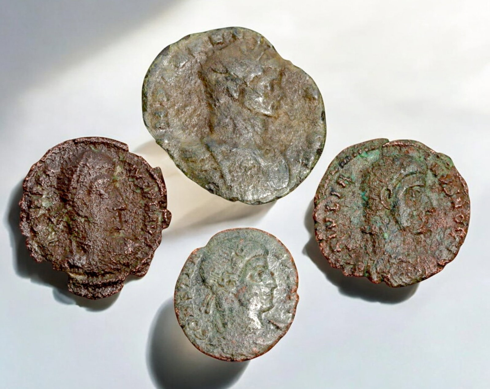 ROMAN EMPIRE: AE Coins - Bronze Coins, 15-22mm, 8.2g (Lot of 4): A collection of four ancient Roman bronze coins, each featuring a distinct imperial portrait on the obverse and various symbolic or military-themed reverses. These coins, essential to Roman commerce a