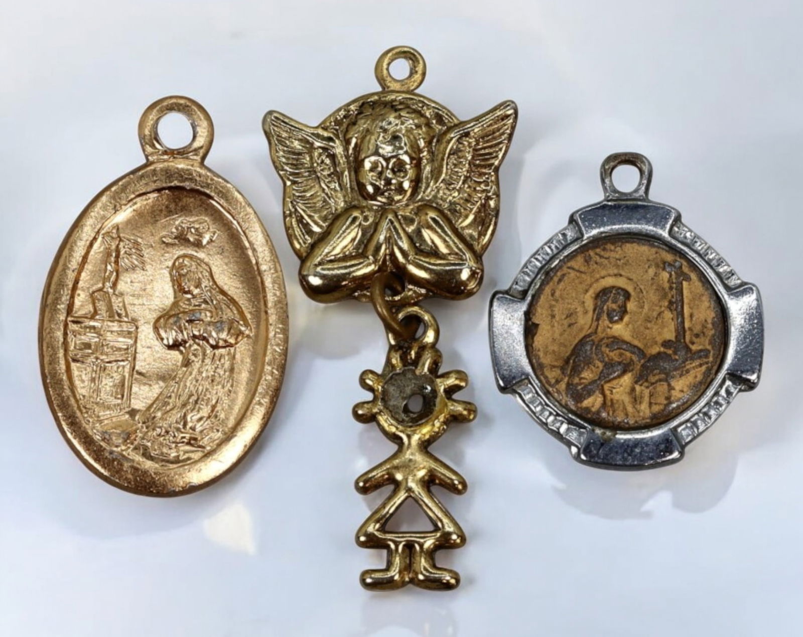ITALY: Antique Religious Medals - 3pcs, 4g, 1.5-2cm, Mid-20th Century: A delicate collection of antique religious medals, totaling three pieces, each measuring between 1.5 to 2 cm with a combined weight of 4 grams. This set includes finely detailed devotional medals feat
