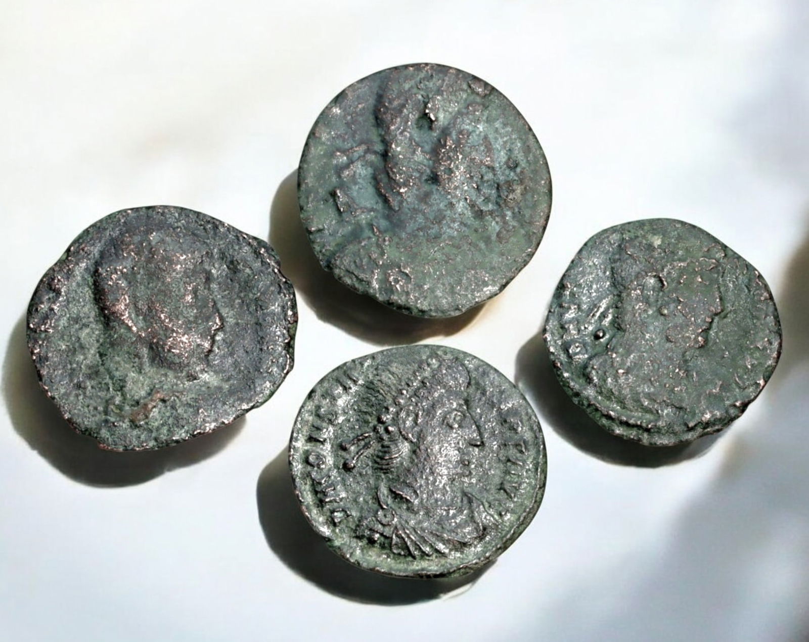 ROMAN EMPIRE: AE Coins - Bronze Coins, 17-20mm, 10.9g (Lot of 4): A collection of four ancient Roman bronze coins, each featuring a distinct imperial portrait on the obverse and various symbolic or military-themed reverses. These coins, essential to Roman commerce a