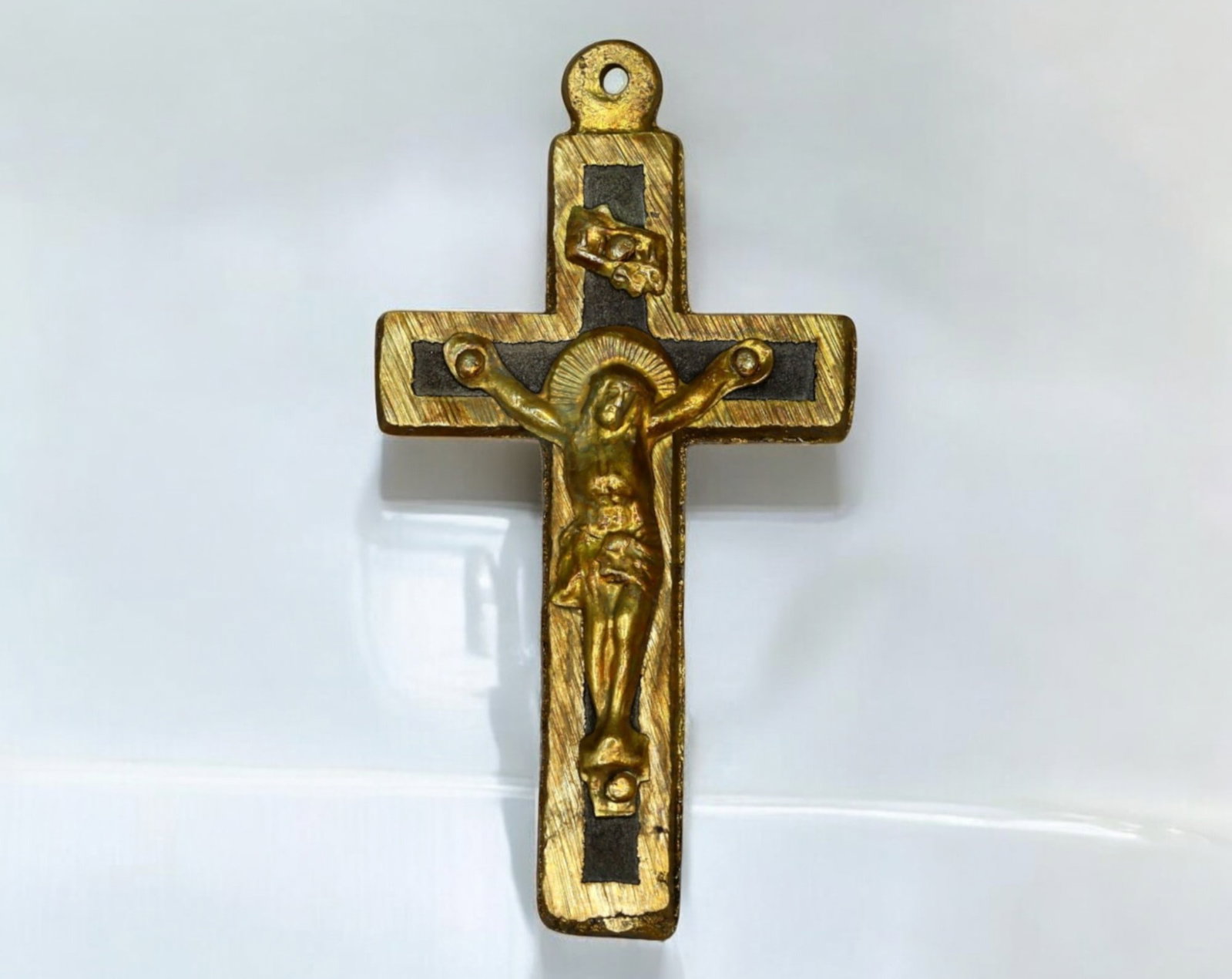 SPAIN: Brass and Ebony Crucifix Pendant - Christ on the Cross with INRI Plaque: A finely crafted brass crucifix pendant featuring a detailed depiction of Christ on the Cross, with an INRI plaque above His head, a traditional abbreviation for Iesus Nazarenus Rex Iudaeorum (Jesus o