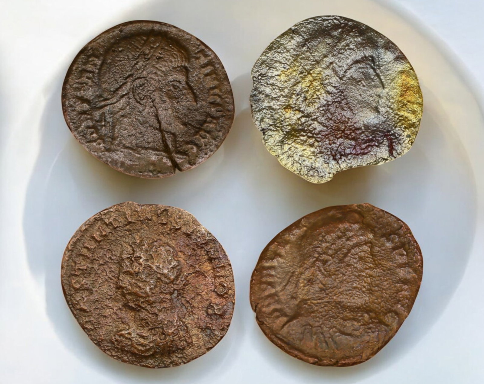 ROMAN EMPIRE: Lot of 4 Late Roman Bronze AE Coins 17-18mm, c. 3rd-5th Century AD: A mixed lot of four late Roman bronze AE coins, representing the turbulent era of the later empire. These coins likely feature emperors from the 3rd to 5th centuries AD, a period marked by military cr