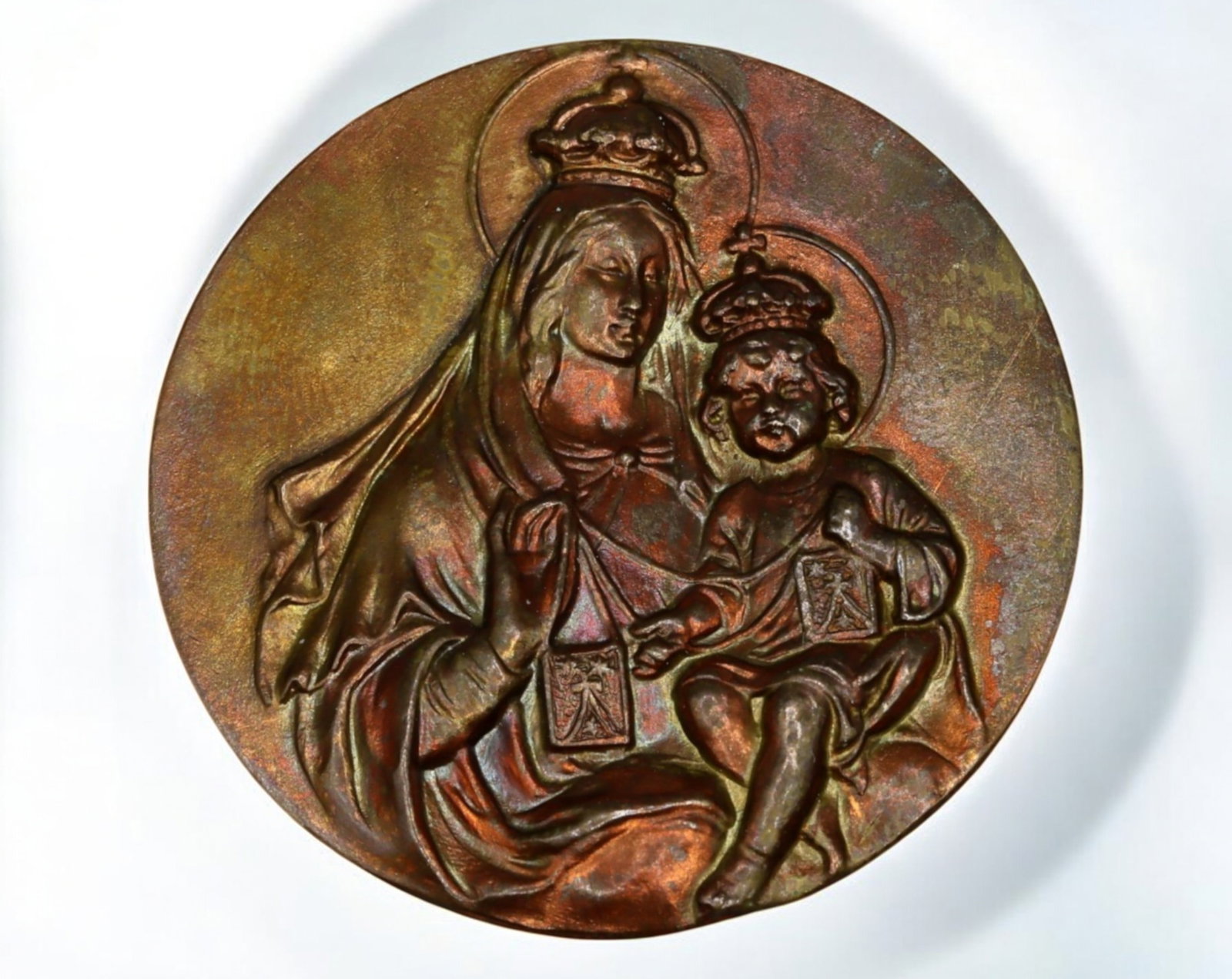 EUROPE: Bronze Plaque - Madonna and Child with Scapular, 4.3g, 4cm: A finely cast bronze devotional plaque depicting the Madonna and Child, both crowned and holding the Scapular of Our Lady of Mount Carmel, a symbol of divine protection and Marian devotion. The delica