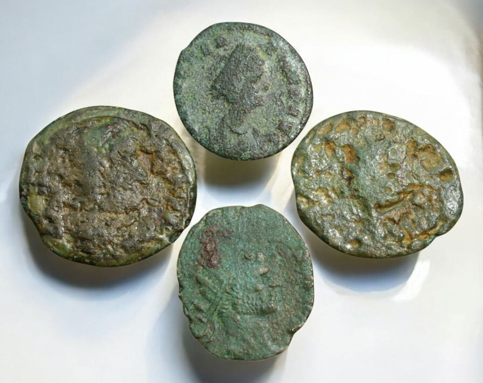 ROMAN EMPIRE: AE Coins - Bronze Coins, 14-17mm, 7g (Lot of 4): A collection of four ancient Roman bronze coins, each featuring a distinct imperial portrait on the obverse and various symbolic or military-themed reverses. These coins, essential to Roman commerce a