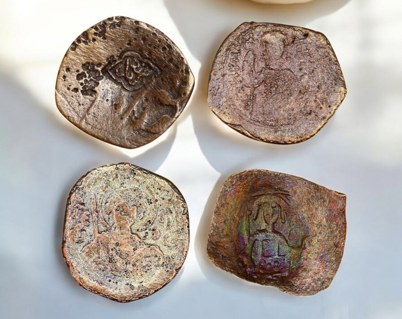 BYZANTINE EMPIRE: Lot of 4 AE Follis Coin - Christ, Imperial & Arab-Byzantine Types, 18-22mm: An intriguing lot of four Byzantine bronze folles, featuring a mix of imperial busts, Christ Pantokrator, and an Arab-Byzantine issue, reflecting the cultural and economic exchanges of the medieval Me