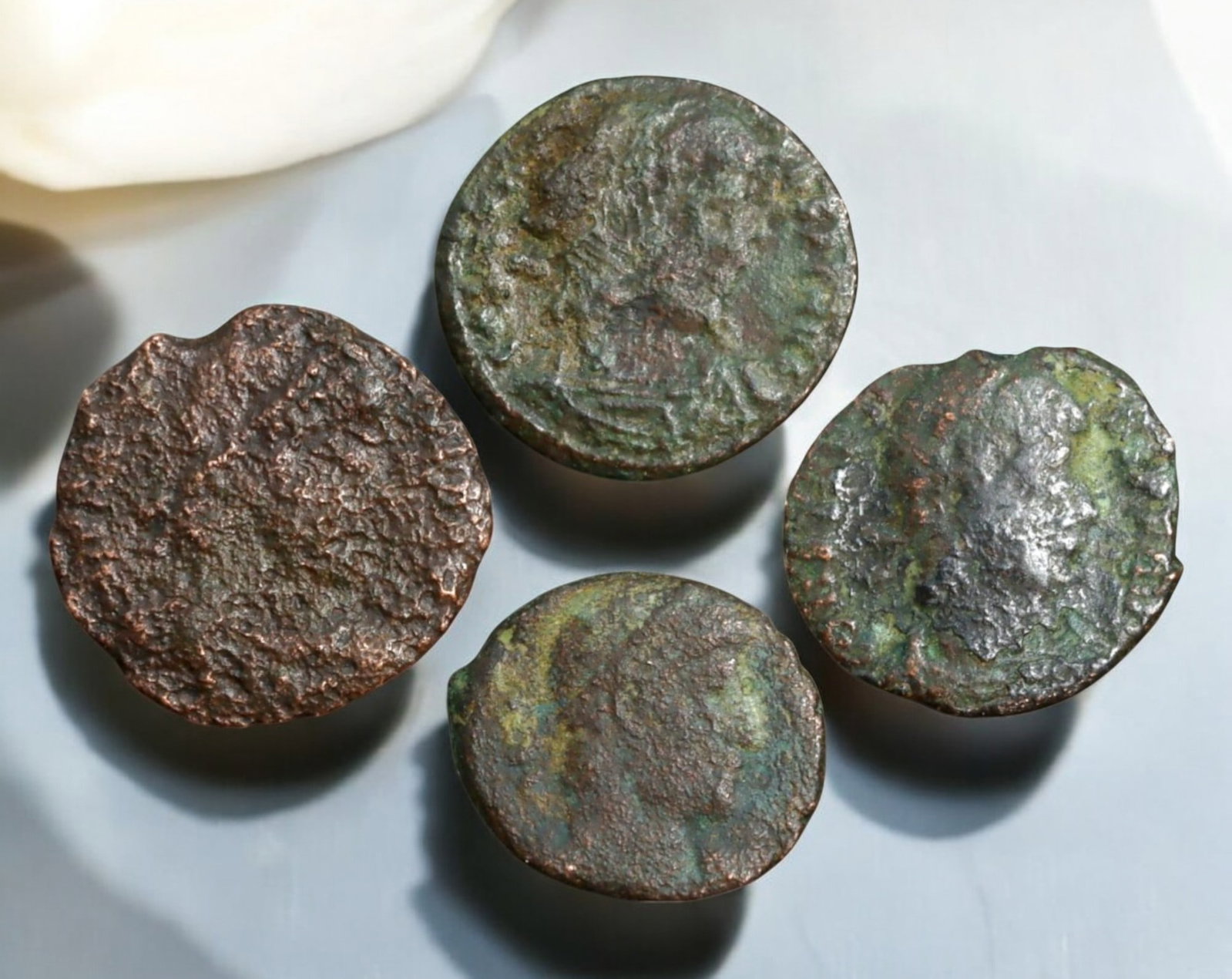 ROMAN EMPIRE: AE Coins - Bronze Coins, 13-15mm, 5.8g (Lot of 4): A collection of four ancient Roman bronze coins, each featuring a distinct imperial portrait on the obverse and various symbolic or military-themed reverses. These coins, essential to Roman commerce a