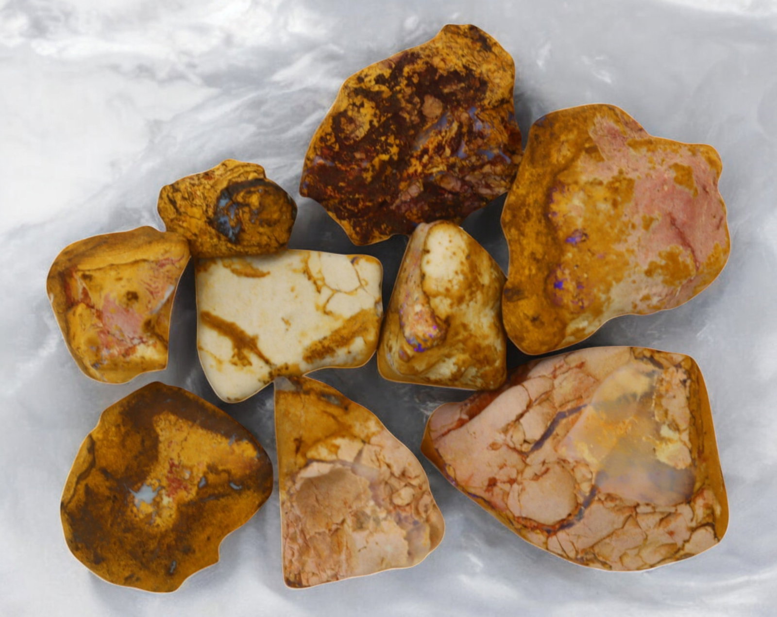 AUSTRALIA: Queensland Fossilized Crystal Opal Rough Lot, 1-4.5cm, 87g (Images Taken Wet): A striking lot of natural fossilized crystal opal rough, sourced from Queensland, Australia. These specimens display an impressive blend of earthy ironstone matrix and vibrant flashes of opalescence, 