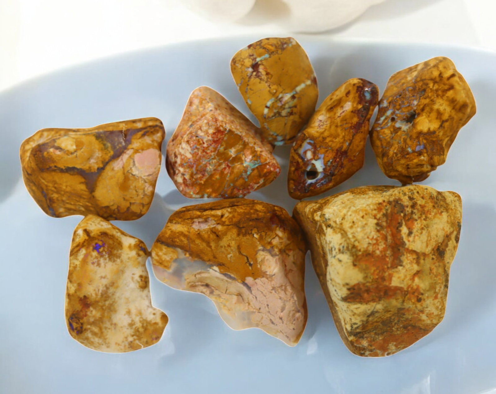 AUSTRALIA: Queensland Fossilized Crystal Opal Rough Lot, 1-4cm, 122g (Images Taken Wet): A striking lot of natural fossilized crystal opal rough, sourced from Queensland, Australia. These specimens display an impressive blend of earthy ironstone matrix and vibrant flashes of opalescence, 
