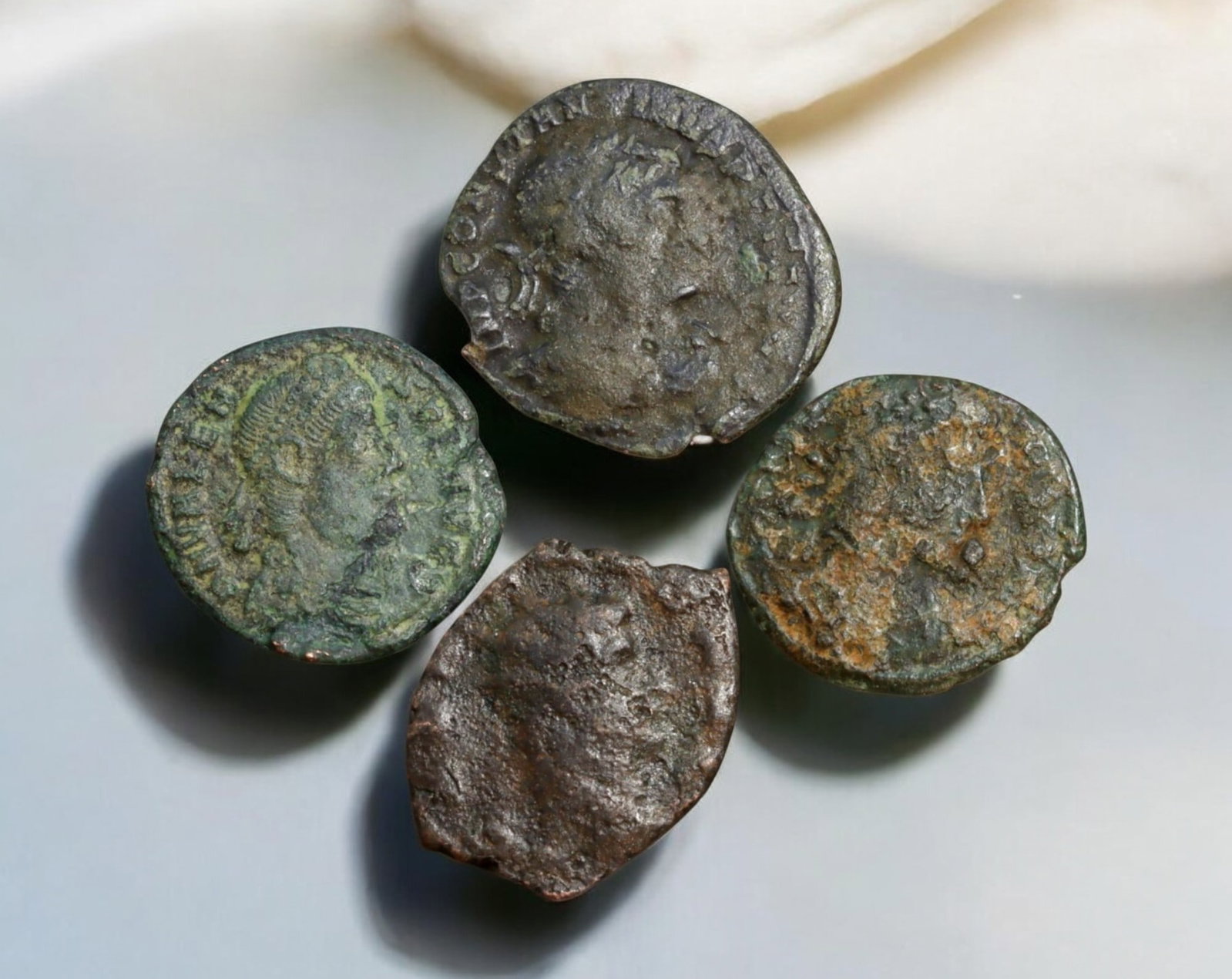 ROMAN EMPIRE: AE Coins - Bronze Coins, 17-20mm, 9.8g (Lot of 4): A collection of four ancient Roman bronze coins, each featuring a distinct imperial portrait on the obverse and various symbolic or military-themed reverses. These coins, essential to Roman commerce a