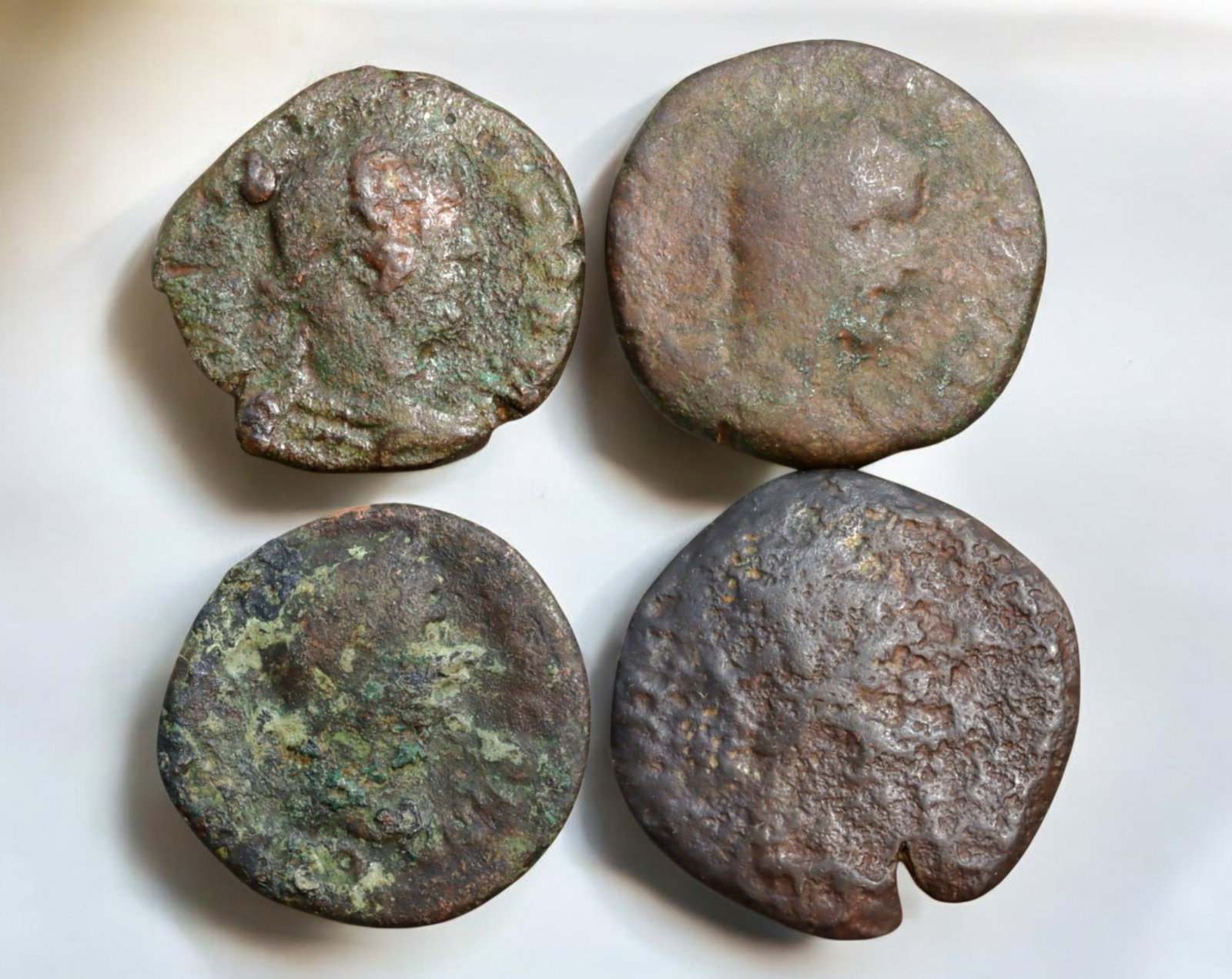 ROMAN EMPIRE: AE Coins - Bronze Coins, 25-28mm, 43g (Lot of 4): A collection of four ancient Roman bronze coins, each featuring a distinct imperial portrait on the obverse and various symbolic or military-themed reverses. These coins, essential to Roman commerce a