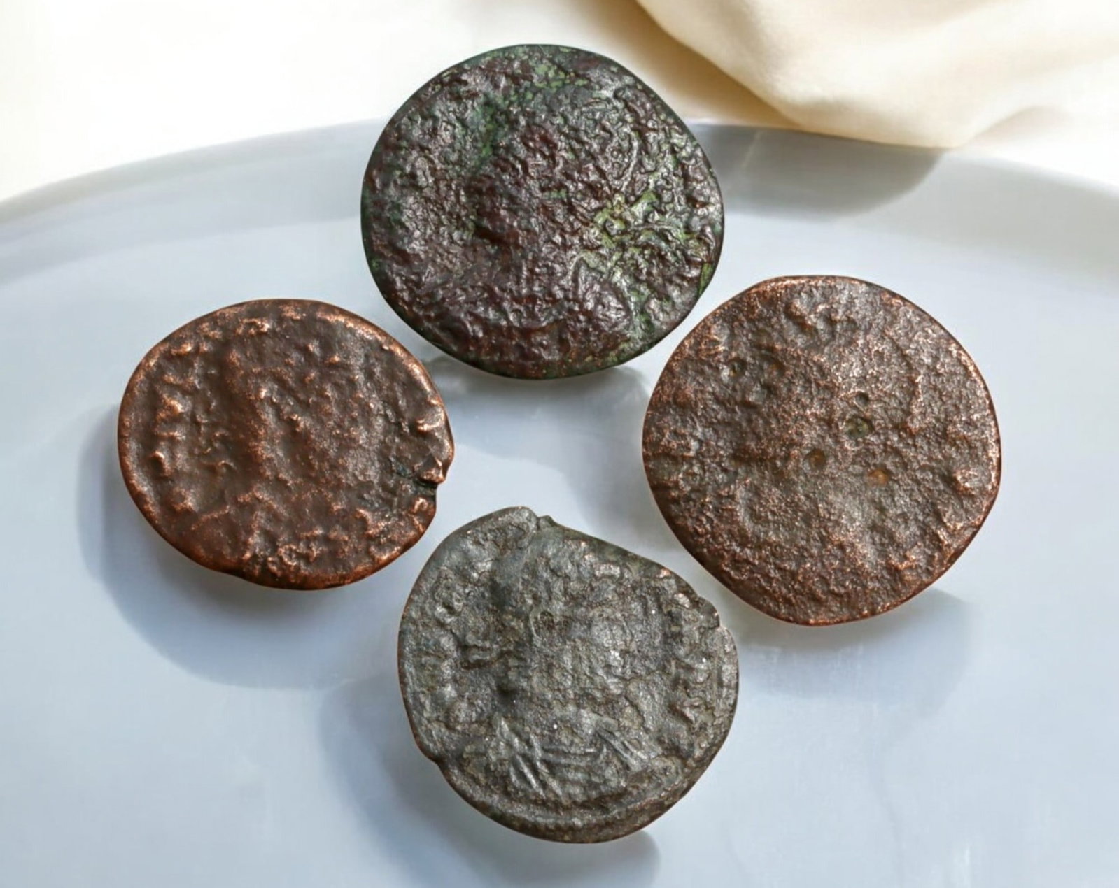 ROMAN EMPIRE: AE Coins - Bronze Coins, 14-16mm, 6.7g (Lot of 4): A collection of four ancient Roman bronze coins, each featuring a distinct imperial portrait on the obverse and various symbolic or military-themed reverses. These coins, essential to Roman commerce a