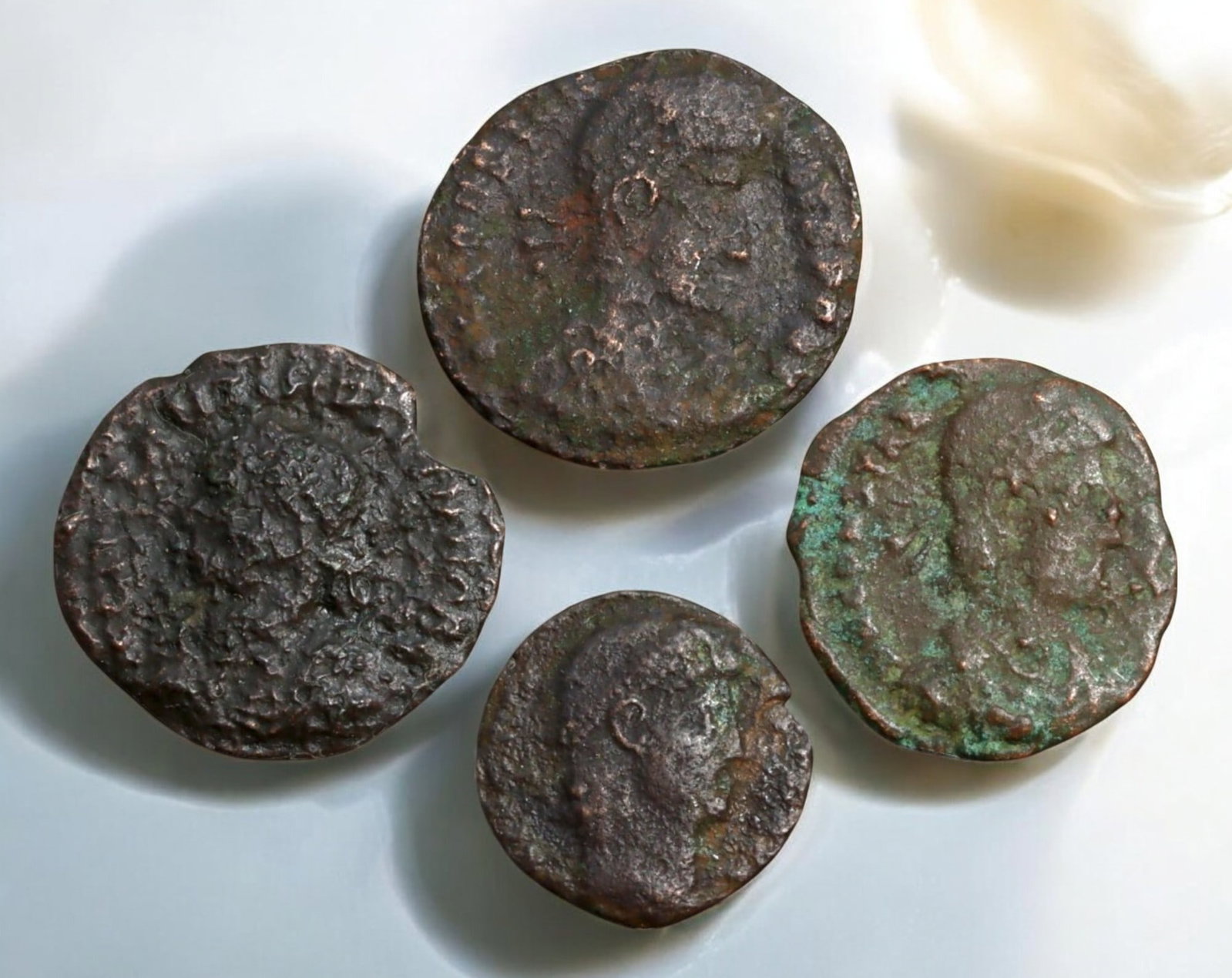 ROMAN EMPIRE: AE Coins - Bronze Coins, 14-17mm, 6.6g (Lot of 4): A collection of four ancient Roman bronze coins, each featuring a distinct imperial portrait on the obverse and various symbolic or military-themed reverses. These coins, essential to Roman commerce a