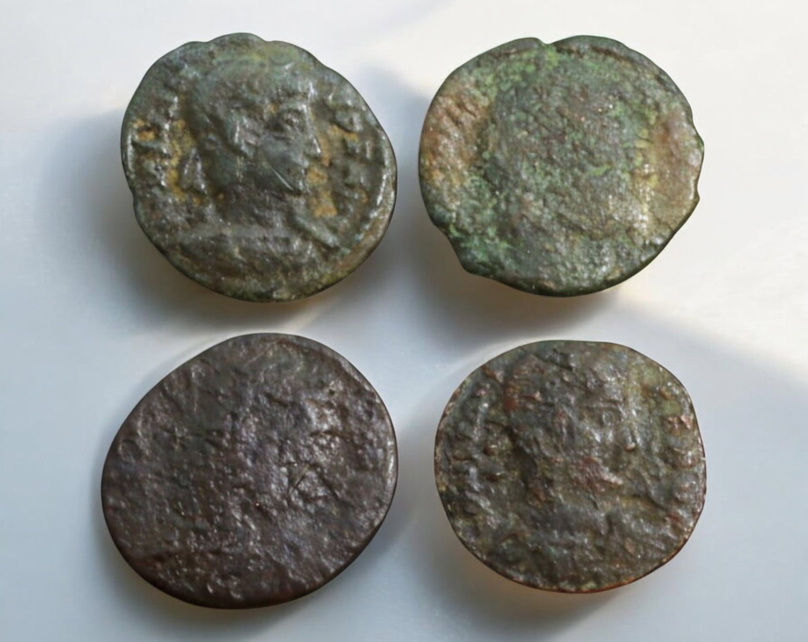 ROMAN EMPIRE: AE Coins - Bronze Coins, 15-16mm, 6.2g (Lot of 4): A collection of four ancient Roman bronze coins, each featuring a distinct imperial portrait on the obverse and various symbolic or military-themed reverses. These coins, essential to Roman commerce a