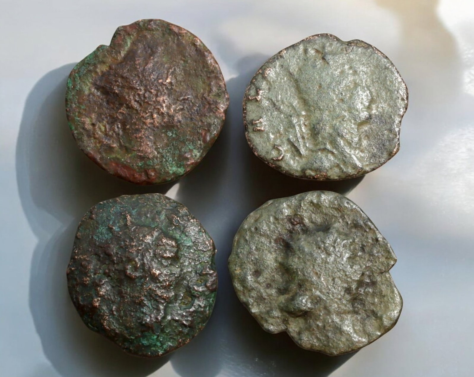 ROMAN EMPIRE: AE Coins - Bronze Coins, 16-17mm, 5g (Lot of 4): A collection of four ancient Roman bronze coins, each featuring a distinct imperial portrait on the obverse and various symbolic or military-themed reverses. These coins, essential to Roman commerce a