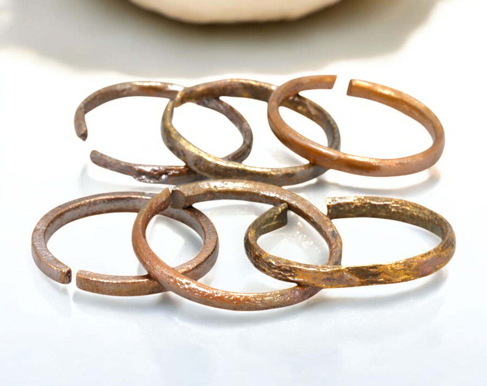 VIKING AGE: Lot of Bronze & Brass Engagement or Wedding Rings - 9th-11th Century: A captivating set of Viking-era engagement or wedding rings, crafted in bronze and brass. These finely shaped rings exhibit a rich patina, with some featuring smooth, polished surfaces while others re