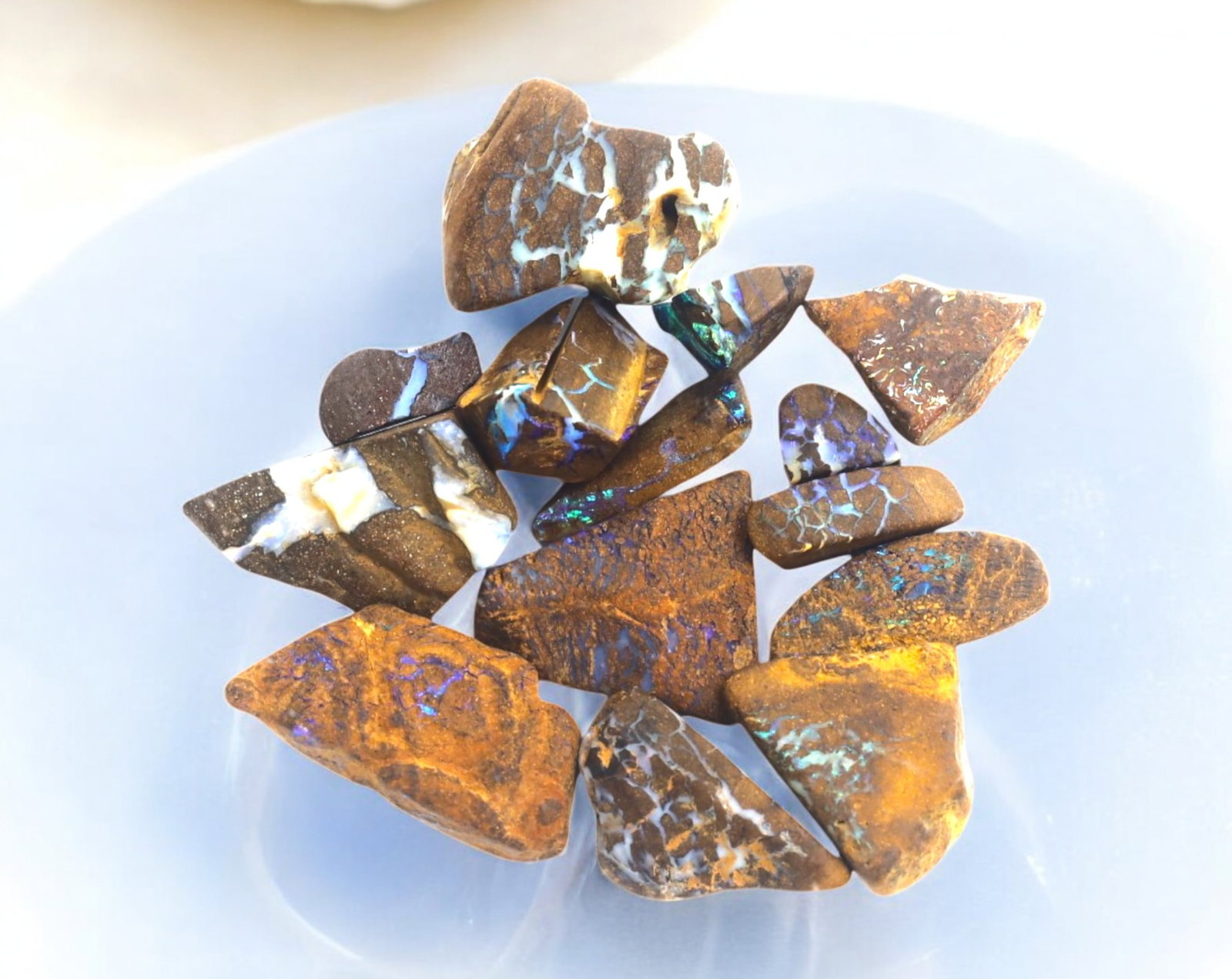 AUSTRALIAN MATRIX BOULDER OPAL - Rough Lot, 0.5-2cm, 24g: A striking lot of natural Australian matrix boulder opal rough. These raw specimens display mesmerizing flashes of blue, green, and gold veins running through ironstone, characteristic of high-quality