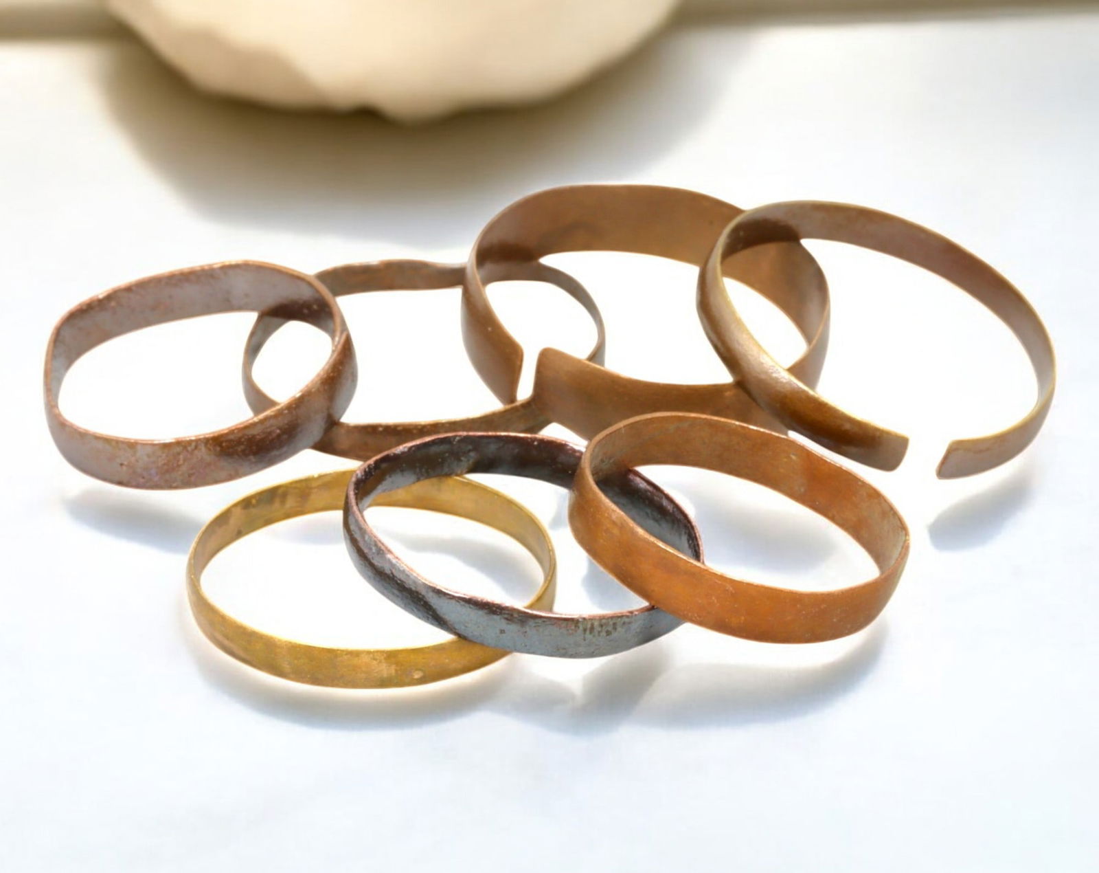 VIKING AGE: Lot of Bronze & Brass Engagement or Wedding Rings - 9th-11th Century: A captivating set of Viking-era engagement or wedding rings, crafted in bronze and brass. These finely shaped rings exhibit a rich patina, with some featuring smooth, polished surfaces while others re