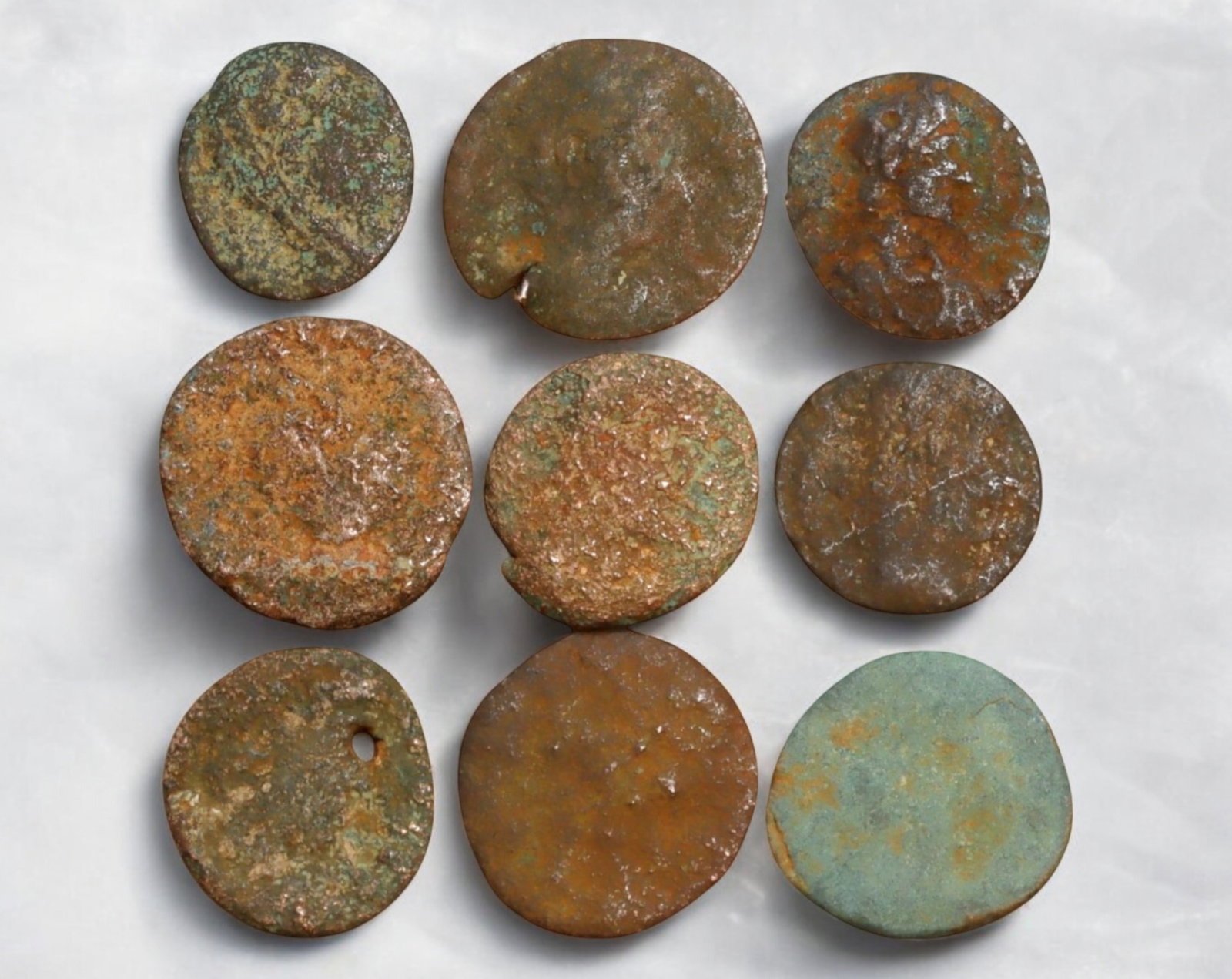 ROMAN EMPIRE: AE Coins - Bronze Coins, 12-15mm, 10.9g (Lot of 9): A collection of ancient Roman bronze coins, each featuring a distinct imperial portrait on the obverse and various symbolic or military-themed reverses. These coins, essential to Roman commerce and go