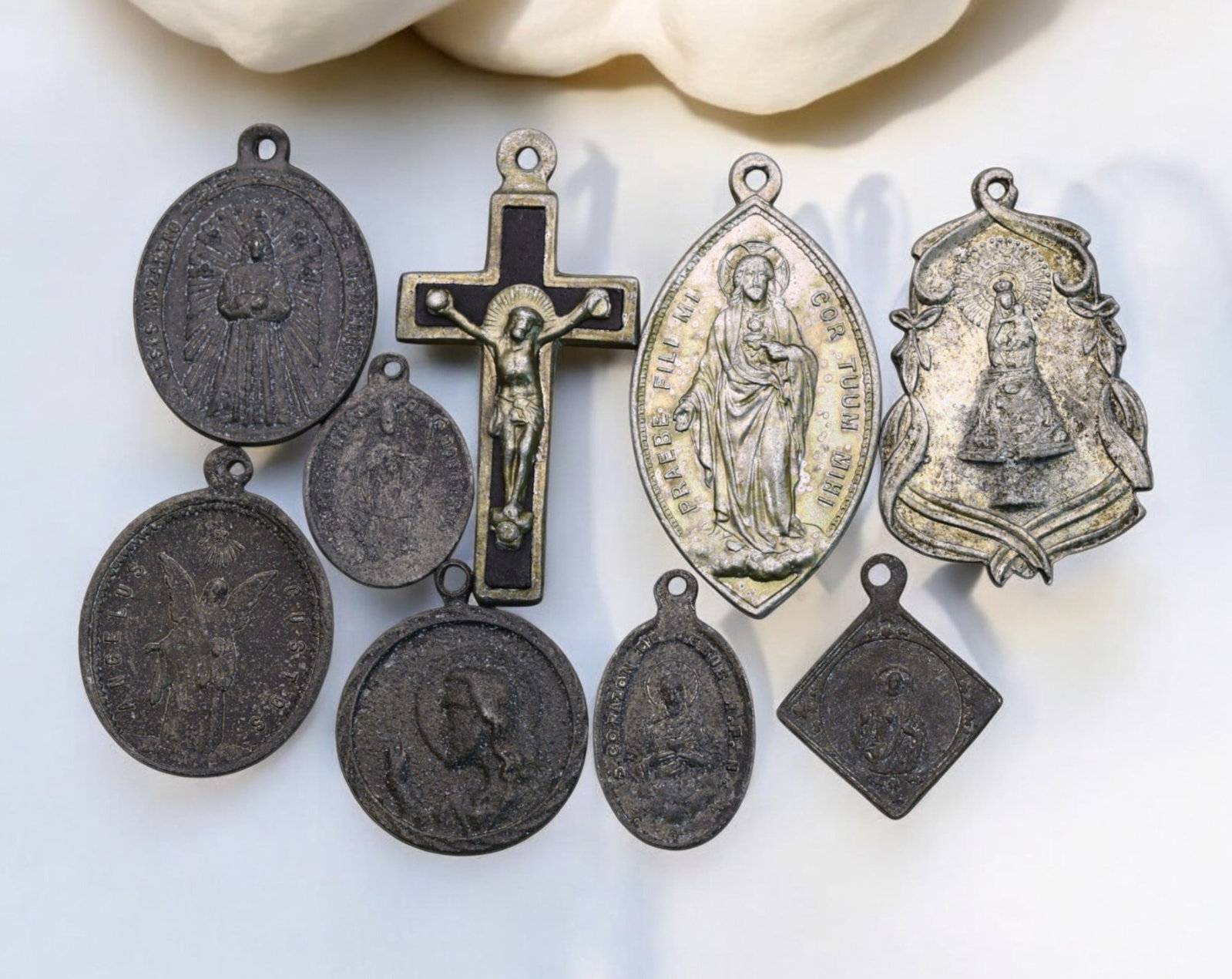EUROPE: Marian & Christological Religious Medal Lot - Sacred Heart & Devotional Icons, (9pcs): An impressive collection of nine religious medals and crucifixes, embodying Catholic devotion with intricate sacred imagery. Ranging from 2cm to 4cm and weighing 10g, 19th-20th Century this lot includ