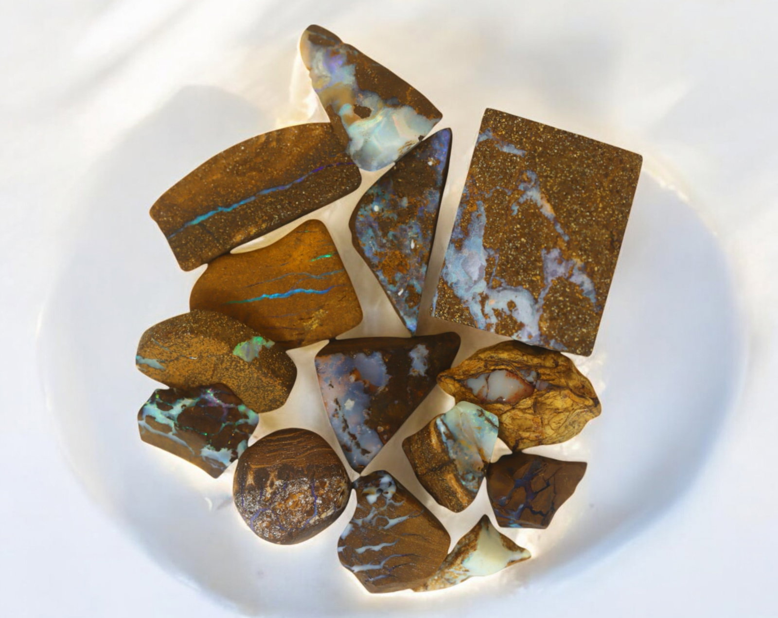 AUSTRALIA: Matrix Boulder Opal Rough Lot, 34g, 1-2.3 cm (Images Taken Wet): Stunning lot of natural Australian matrix boulder opal rough, these specimens showcase a vibrant interplay of opalized veins and swirls embedded in rich ironstone, displaying flashes of electric blues